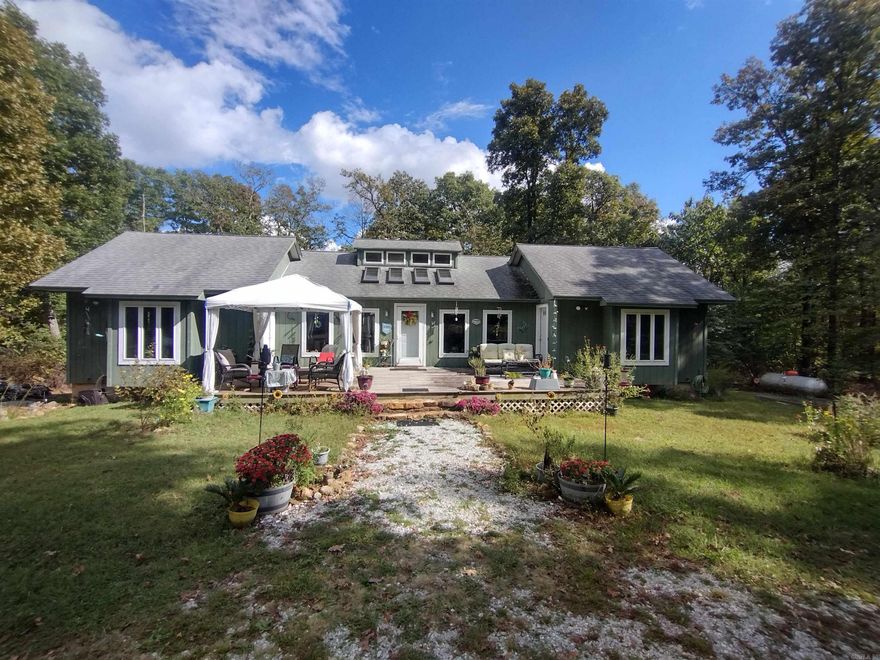 Your special place in the Ozark Mountains! Perfect vacation rental, or even your forever home. Surrounded by nature, the flowers and wildlife will make you forget you're only 15 minutes from the culture and charm of Mountain View, Arkansas. This peaceful retreat features a main house and accompanying cabin, separated by a cultivated wildflower garden, small fish pond, horseshoes and fire pit for evening gatherings. The large wooden deck off the main house is the perfect place to relax and watch the deer and turkey as the sun sets. The home generator and full basement with a safe room add more peace of mind, while the extra-large windows and skylights in the common area bring the outdoors inside in a way words can hardly express. When coming up the long driveway through the trees, this hidden escape appears suddenly, as a secret Eden revealing itself. The main house features 2 suites with showers and living/dining/kitchen common area between the two. A full unfinished basement with a walkout door gives you a clean slate to make your own vision come to life. The cabin features 1 bed and 1 bath with a kitchenette and fully screened porch, and RV Hookup