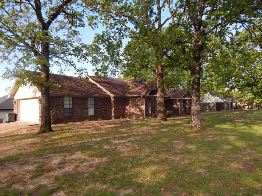 This property is convenient to I-40, Hwy 65, and close to multiple colleges, making it a perfect place for a family or for multiple college students. This affordable home is walking distance to Sonshine Academy. Spacious 3 bedroom 2 bath house with a privacy fence and a side-entrance double garage. The best room in the house is the large family room with a wood burning fireplace. Efficient kitchen, separate laundry area, breakfast bar, and windowed dining area. With a split floor plan, everyone has plenty of privacy. The primary bedroom has a walk-in closet plus another separate closet. In fact, there is an abundance of storage throughout the home. At the end of the day, step out the back door onto a nice deck with the fenced yard.
