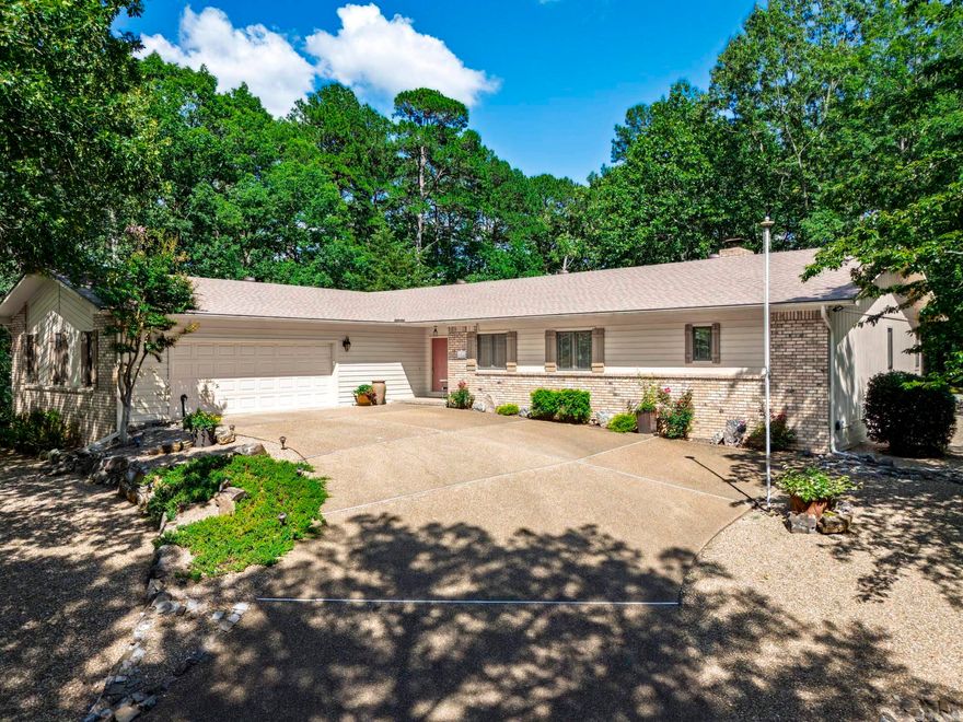 The moment you drive down the street you begin to notice the peaceful setting of this beautiful home situated on two lots giving you the privacy you desire. This well maintained home has numerous areas to entertain in allowing you to choose between the vaulted great room/dining room with a cozy fireplace and convenient wet bar, a magnificent sunroom with walls of windows taking in the beauty of nature in Hot Springs Village or a den/family room that could easily be a third bedroom. The kitchen has an abundant amount of beautiful wood cabinets with a bar area open to the breakfast area. Primary suite has large bedroom with two walk in closets and a bath featuring a walk in shower and soaking tub. Fantastic storage in the conveniently located laundry close to primary suite. Separate study for your home office. Separate guest bedroom and guest bath with walk in shower. Garage is oversized with a work bench and deep enough for the four door pick up truck. Located off the ridge of Asturias Drive that is conveniently located to Coronado Center and close to West Gate amenities. Roof 2022, HWH 2023, HP 2021. Generac generator. AGENT REMARKS for further details on possession.