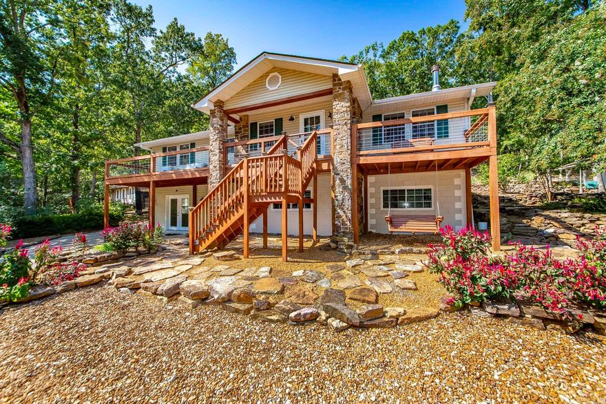 Tucked into a serene, park-like setting, this beautifully updated home delivers flexible living on nearly 2.3 acres and the best of the Fairfield Bay lifestyle. The primary 0.79±-acre homesite is complemented by a 1.5±-acre parcel directly across the street that conveys, creating room to spread out.  Enjoy a partial winter view of the lake and a quick 5-minute trip to Greers Ferry Lake and the pools, pickleball, tennis, golfing and other amenities of the Bay. Outdoor adventurers will love having 80+ miles of ATV/UTV trails nearby, along with scenic hiking and biking. Designed for effortless multi-generational living or extended-stay guests, the lower level includes 2 bedrooms, a full kitchen, living room, bathroom, and a gym. Upstairs, a bright family room flows to the kitchen and dining areas, plus a convenient laundry room. The primary suite and guest bedroom both feature extra-large walk-in closets and beautifully updated bathrooms. Fresh interior paint, newer appliances, and a new deck make this home truly move-in ready. Bring your toys—there’s RV parking with water and electric hookups, too. Many upgrades have been made to this property.  Schedule your showing today.