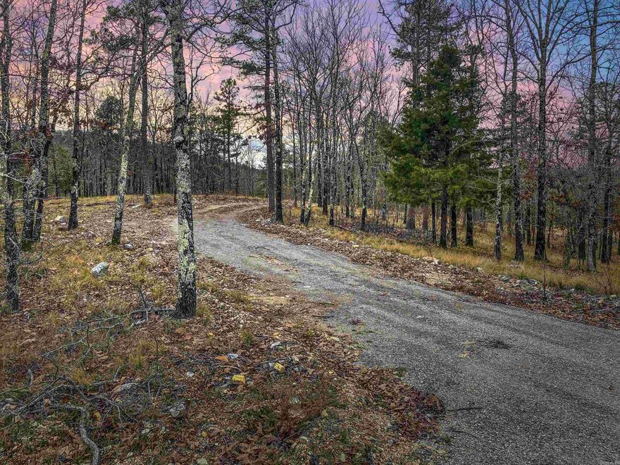 Discover 9.43 acres of natural tranquility on Shorthorn Lane, Hot Springs, AR 71901. This idyllic property boasts rolling wooded landscapes, flowing creeks, and fire pits for a serene retreat. Surrounded by a Hunting Club's acreage, it offers undisturbed wildlife and stunning mountain views. Accessible via gravel roads, it's just minutes from downtown Hot Springs and 40 minutes to Little Rock. Ideal for building a dream home with a pond in the deep valleys, this property promises endless possibilities for development (verify with the Deed Restrictions). Embrace the perfect blend of seclusion and convenience on Shorthorn Lane.