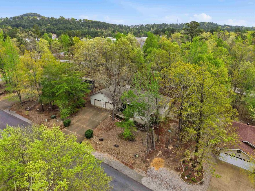 Rare find priced to sell on the East Side of The Village! Beautifully maintained and thoughtfully updated, this handicap accessible home showcases engineered hardwood flooring, freshly retextured walls, and modern paint throughout. The inviting living room features a cozy gas log fireplace and flows seamlessly into a bright, airy sunroom that's climate controlled. A private office sits just off the laundry room, providing the perfect space for work or hobbies. The primary suite offers direct access to the back deck and an en-suite bath equipped with a dedicated water heater. Step outside to enjoy the expansive wraparound deck, accessible from the primary bedroom, office, and sunroom—ideal for outdoor relaxation and entertaining. Additional highlights include a fenced backyard, whole-house vacuum system, and an oversized two-car garage. VA-approved handicap accessible modifications completed in 2008! Schedule your showing today!