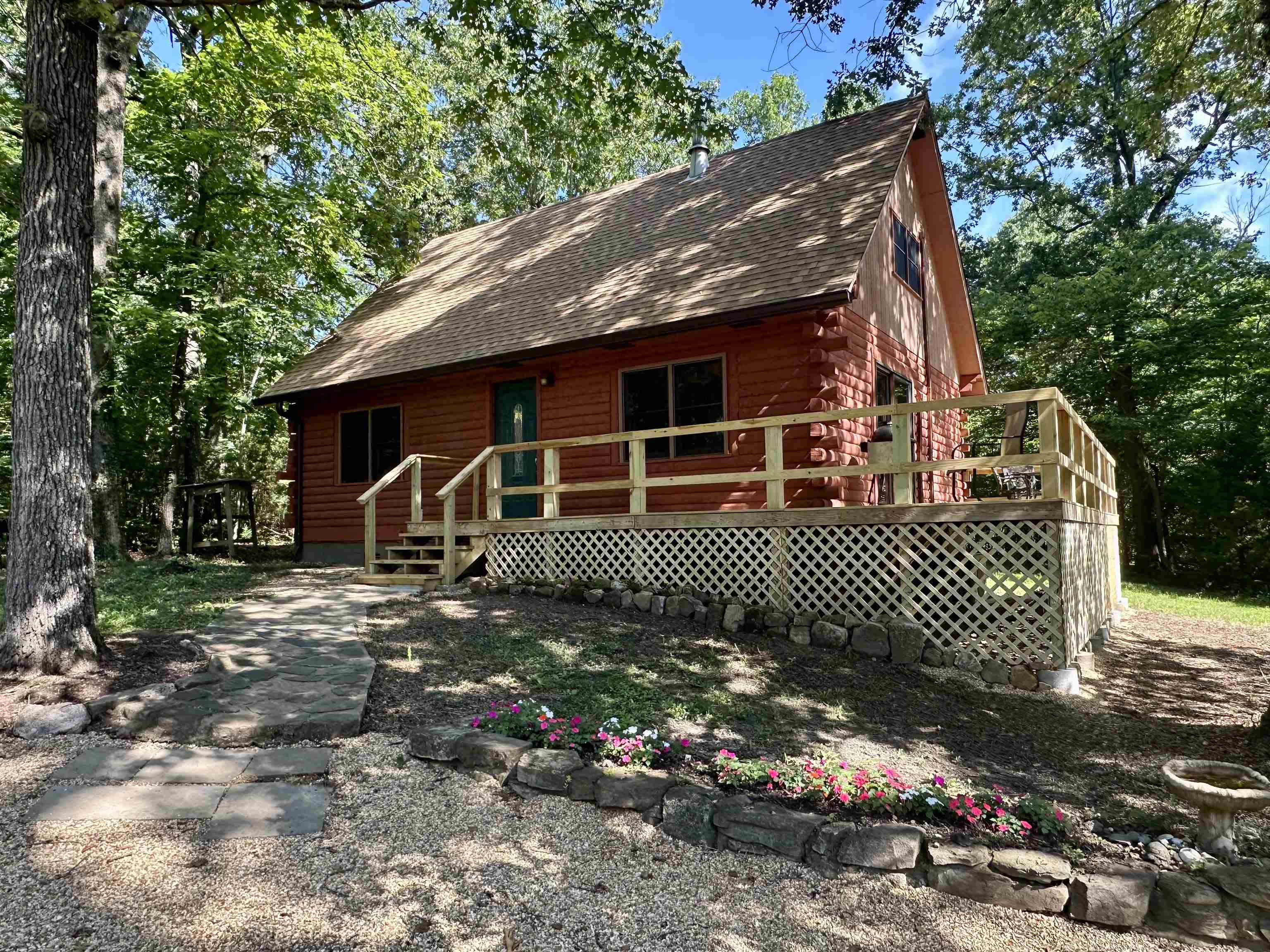 Charming 2-Bedroom Home on 3.29 Acres – Minutes from Bull Shoals Lake! Welcome to your peaceful retreat just 5 minutes from Bull Shoals Lake access! This beautifully updated 2-bedroom, 1.5-bath home sits on a private 3.29-acre lot and combines modern upgrades with cozy comfort. Inside, you'll find a warm and inviting living space featuring a HearthStone wood stove—perfect for relaxing evenings and efficient heating throughout the cooler months. The home has been thoughtfully updated in 2025 with a new bathroom, stainless steel appliances, water heater, and new roof with seamless gutters, offering both style and peace of mind. Step outside to enjoy the large deck, ideal for entertaining or simply taking in the natural surroundings. A detached garage/shop provides tons of storage space and room for projects, hobbies, or outdoor gear. Whether you're seeking a full-time residence or a serene weekend getaway, this move-in-ready property offers privacy, modern comforts, and quick access to one of the area’s most beautiful lakes. Don’t miss this one!