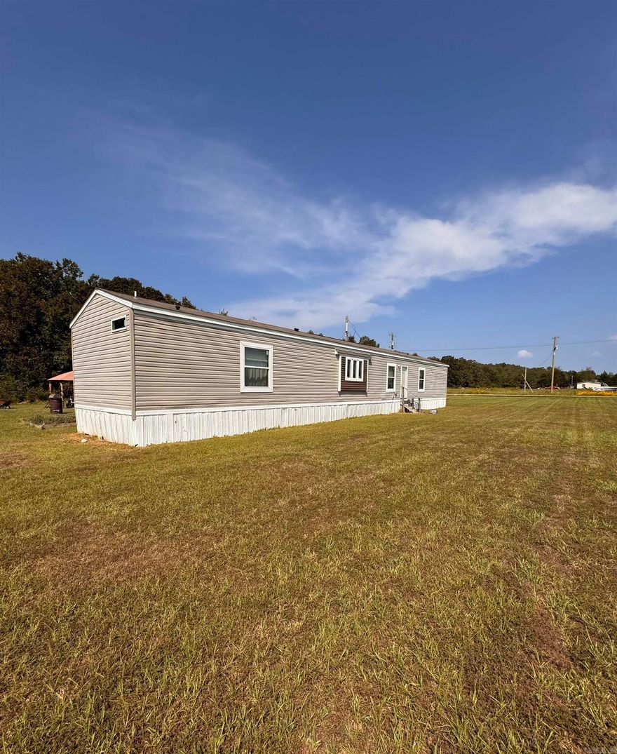 Priced to sell fast!!! Move in ready and country living! This 3-bedroom, 2-bath mobile home sits on 3 flat and usable acres, perfect for enjoying wide open spaces, gardening, or simply relaxing in peace and quiet. Plenty of room for the family, pets, or hobbies — all just a short drive to town conveniences.