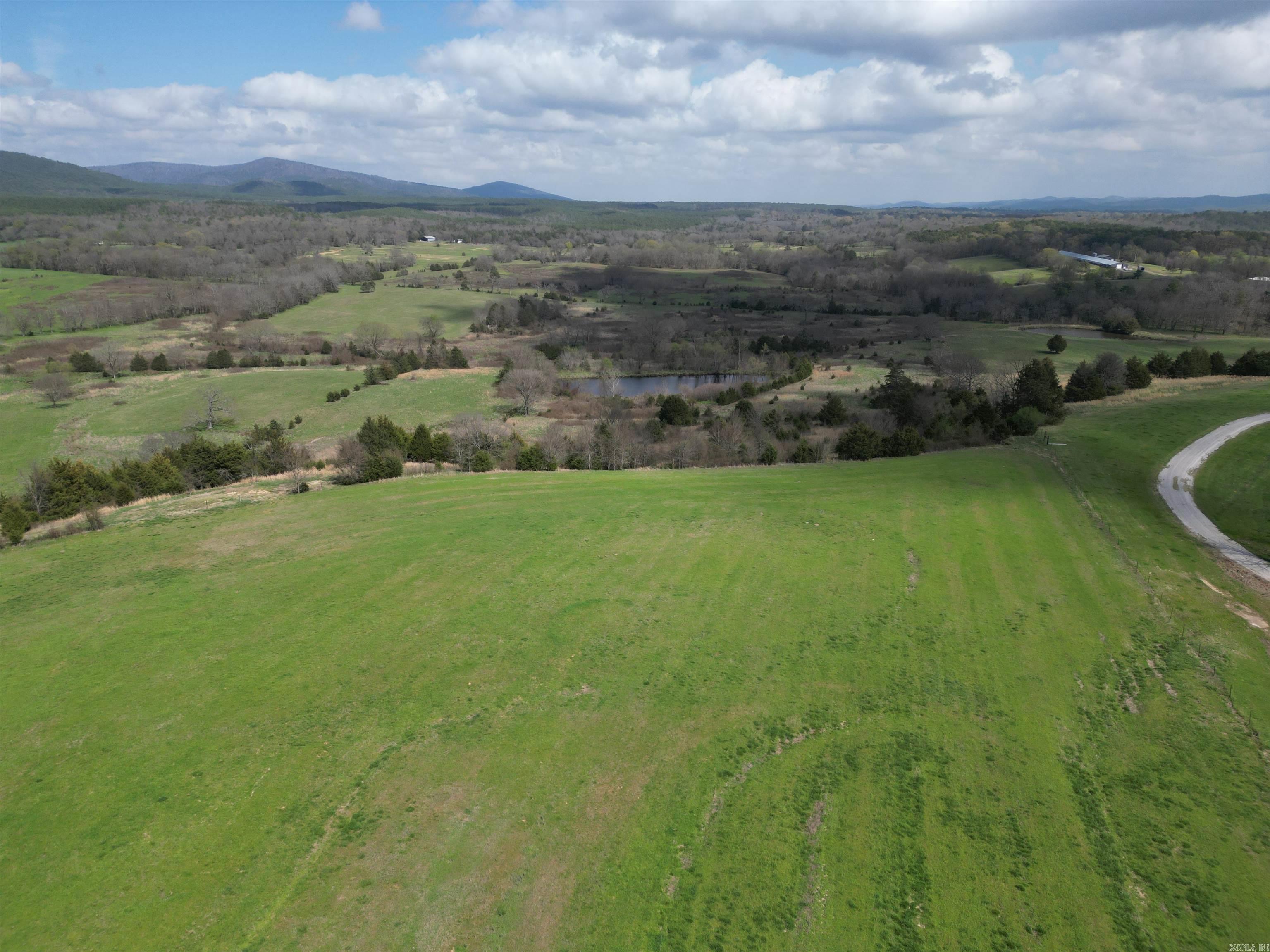 Discover your own private retreat on this extraordinary 70-acre property, offering breathtaking mountain views, rolling hills, and an abundance of natural beauty. Located just minutes from the renowned Wolf Pen Gap and the scenic Fouche and Rich Mountains, this sprawling estate is a dream for outdoor enthusiasts, with endless opportunities for hiking, biking, and exploring the great outdoors. Enjoy the tranquility of your very own spring-fed pondāperfect for fishing or simply soaking in the beauty of nature. The pond, surrounded by lush greenery, adds to the serene atmosphere of this one-of-a-kind property. Start your adventure immediately with the included 24' all season yurt kit and box trailer, perfect for temporary living or as a unique getaway. These versatile additions allow you to enjoy the property right away. This property is ready to support your future development. With a well already on-site and an electrical pole with a meter pan, the infrastructure is in place to make building your dream home easier than ever. Whether you're looking for a private estate, a recreational getaway, or a property to develop, this parcel offers unparalleled potential.