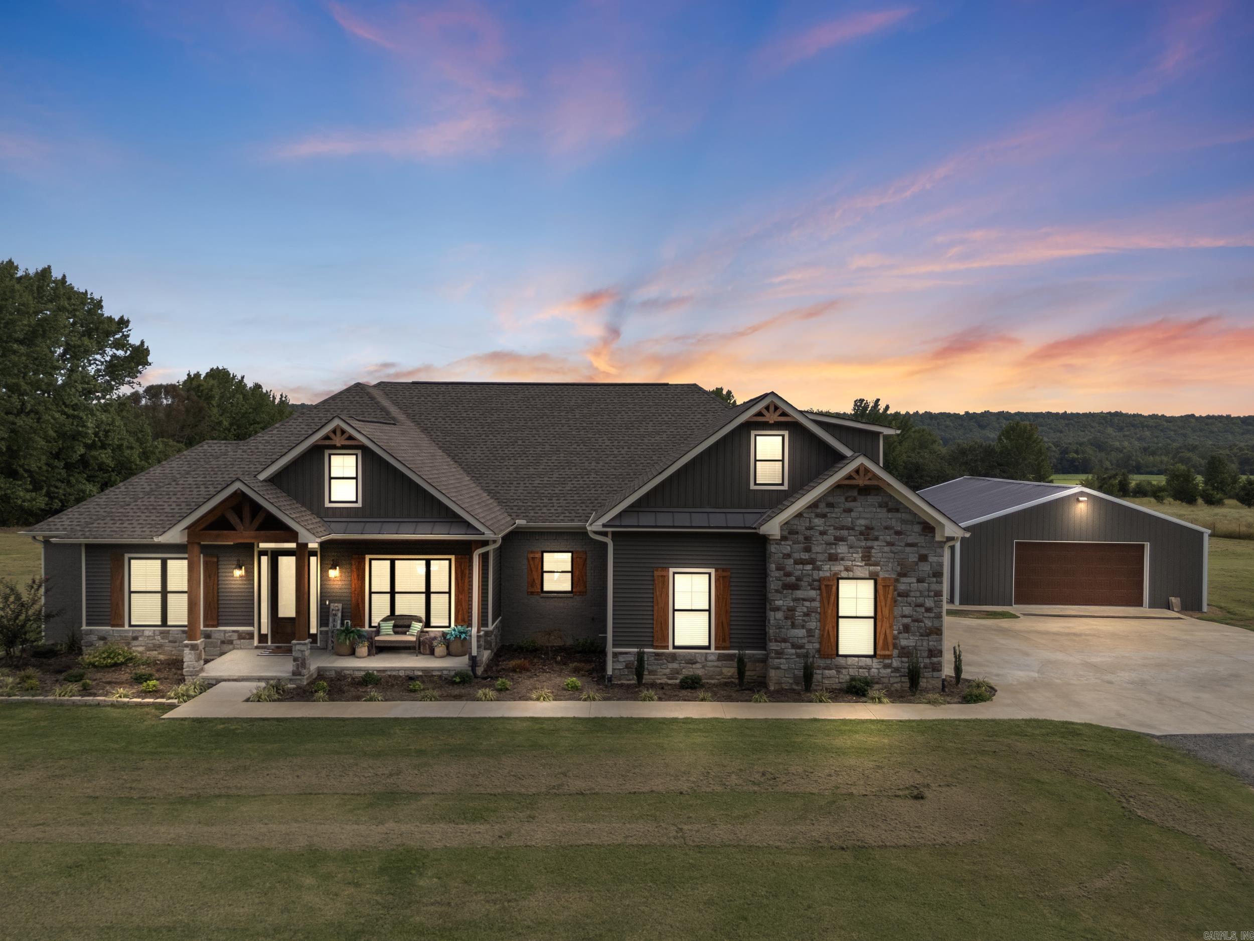 Stunning custom craftsman home on 6 acres with 30'x40' shop, and new saltwater pool. Open floor plan with 10' ceilings, gas log fireplace with painted brick accent. Custom features include wainscoting, craftsman baseboards and crown molding, mud room with built in cubbies and bench, and so much more. Chef's kitchen with two ovens, convection microwave, gas cooktop, quartz countertops, pot filler, and huge walk-in pantry. Kitchen sink looks out to pool and meadow. Split floor plan with primary suite tucked away. Primary suite features a custom tile shower, soaking tub, make-up vanity, oversized closet that connects to laundry room. The other 2 downstairs bedrooms have walk-in closets and a Jack and Jill bathroom. Upstairs you'll find a 550 SF bonus room that could be a 4th bedroom, media room, game room, or flex space. Covered front and back porches. The back porch looks out over the pristine saltwater pool and backyard. Beyond the backyard is a large pond and grove of trees. You cannot beat this private setting. Perfect home for entertaining. Plenty of space both inside and out. Great location, only 15 minutes to Conway. Vilonia Schools. Schedule your private showing today!