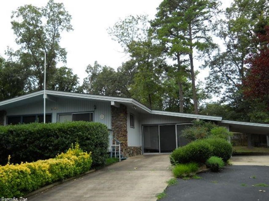 Spacious greatroom with large rock fireplace and vaulted ceiling. Floor to ceiling windows, Hardwood under carpet. Open floor plan could be very easily updated.  Good sized bedrooms.  Sunroom is included in square footage. Nice neighborhood close to Greers Ferry lake.   See agent remarks.