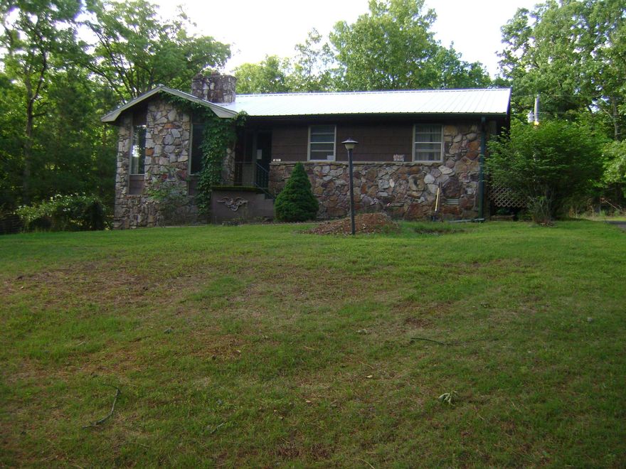 GREAT FAMILY OR RETIREMENT HOUSE ON TWO LOTS !! This is a 3 bedroom, 2 bathroom home with large family room & gas-log fireplace. A nice size master bedroom with outside access to one of two decks also providing entry. The house has central heat /air with a heat pump system. A very nice yard with a dog play area is fenced in for safety. It has a storage shed, with a two car carport attached to the house.  The small basement area can be used as a safe room or storage area.  COME SEE THIS GREAT HOME TODAY.