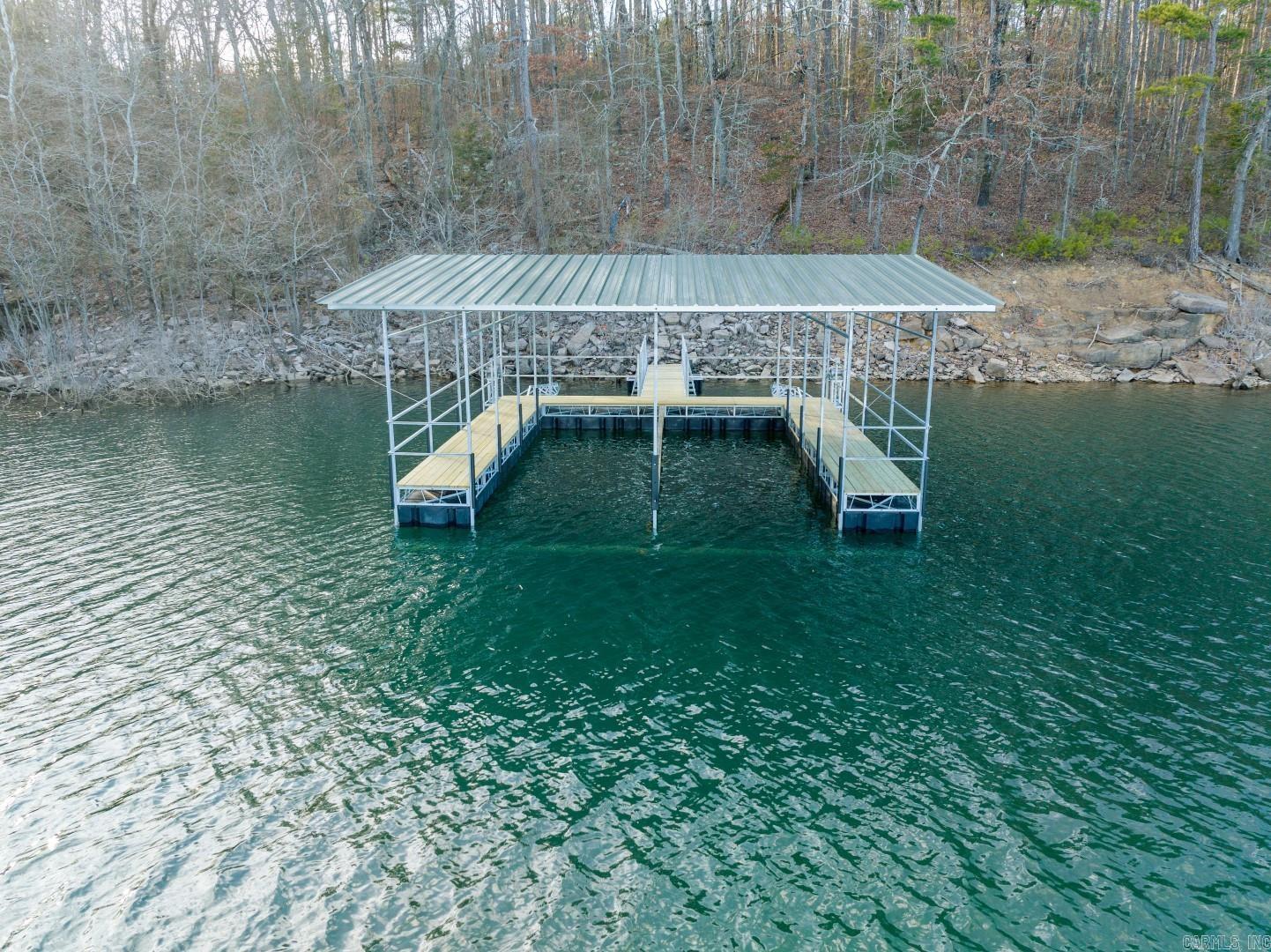 Lakefront lot with 2-SLIP BOAT DOCK!!! This 3.25 acre LAKEFRONT LOT includes a BRAND NEW 2-SLIP BOAT DOCK, and is located in the brand new Vida Del Lago subdivision! Gated entry, paved road, all lots are 3+ acres, thoughtful Bill of Assurance, 2,000 square foot minimum, docks are shielded from the wind nicely in a cove, POA Assessments have not yet been determined, taxes not yet determined. The backyard of the lots face to the east and and will be shaded nicely in the afternoon! You can't beat the location, the orientation or the niceness of this new, first-class, lakefront subdivision! Power will be run once construction begins! Subdivision is located adjacent to the Twin Coves Subdivision in Greers Ferry.