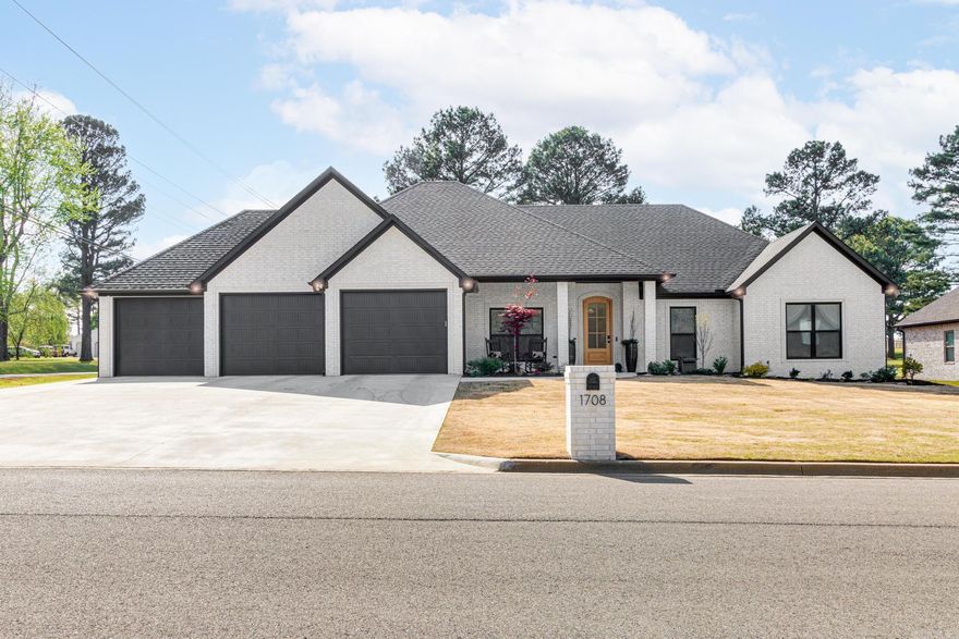 This Modern Ranch 5 bedroom home has everything you may be looking for and more, the inviting entry and open floor plan exudes luxury and comfort, the expansive screened in porch with brick fireplace( 22x38) and wood vaulted ceilings adds additional space for entertaining, the split bedroom plan gives privacy for the primary suite suite and adds another primary suite for guests and a three bay garage is avail for extra storage. All white Kitchen cabinetry with an Island bar plus and additional 13ft of black cabinetry was added for double panties, built in buffet and dining area, granite counter tops throughout including new granite added last year and luxury plank vinyl flooring set off this modern farmhouse vibe. The large great room has a stone accented gas fireplace with shiplap surround. Plenty of storage and room to entertain in this brick home with corner lot, horizontal fenced backyard with two gates, extra landscaping all make this a cozy ready to move in to option for buyers seeking the south area of Paragould.