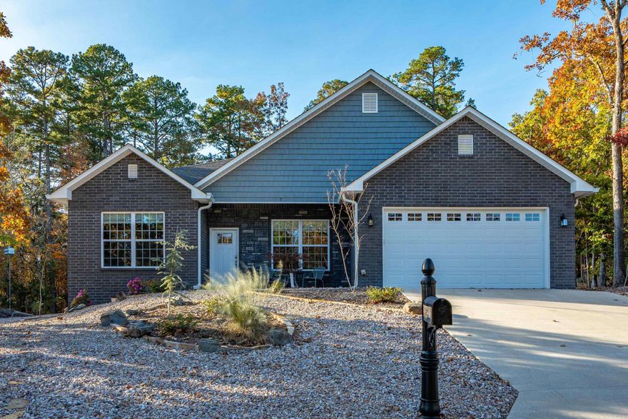 Experience modern comfort wrapped in a peaceful, park-like setting in this beautifully crafted 3-bedroom, 2-bath home built in 2023. Thoughtfully designed, it offers a true retreat atmosphere while keeping you close to all the exceptional amenities of Hot Springs Village. Step inside to a bright and inviting floorplan, where large windows fill the space with natural light and highlight the home’s open, airy layout. The spacious kitchen seamlessly connects to the living and dining areas—perfect for everyday living, hosting friends, or entertaining with ease. The primary suite provides a calming private escape, while two additional bedrooms offer versatility for guests, a home office, or creative space. Outdoors, enjoy the beauty of the surrounding nature—sip your morning coffee on the patio or unwind in the tranquil, wooded setting. Located within Hot Springs Village, you’ll have access to world-class golf courses, scenic lakes, walking trails, fitness facilities, and gated security—all at your fingertips. Discover the perfect blend of nature, comfort, and community in this modern retreat.