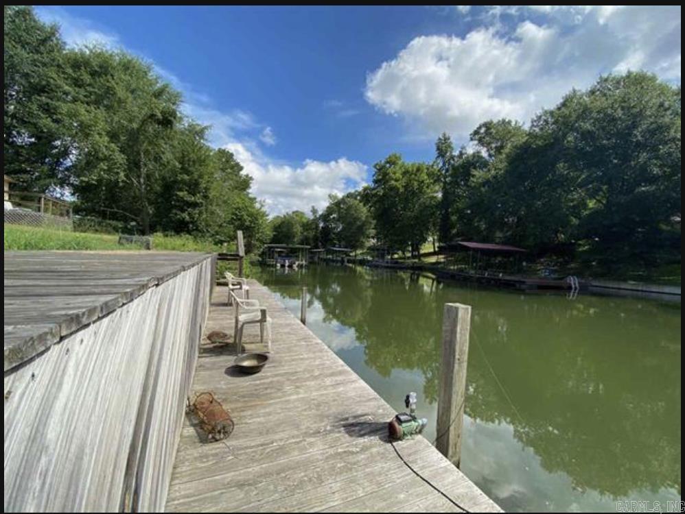 1700 SQ' Shop on 0.29 acres with 50' of shoreline on Lake Hamilton. Lake Hamilton School Dist. 50' boardwalk is considered a boat dock by Entergy, so your boat can stay there longer than the two-week limit. Land will not perc.