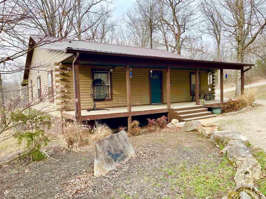 NEW LISTING IN SALEM AR! LOG Home in Fulton County on 5.41 Acres. 3 bed, 1 bath log home offering 1,769 sq ft of rustic Ozarks charm with modern upgrades. Dishwasher and refrigerator(2026) Open floor plan, featuring hardwood floors, vaulted tongue-and-groove wood ceilings, and metal ceilings in the sunroom and bedrooms. REMODELED full bathroom (2026) with a genuine PORCELAIN claw foot tub. Covered front and back PORCHES to enjoy the peacefulness.  A new metal roof (2024), ELECTRIC/SOLAR heat pump, propane fireplace, and SPRAY FOAM insulation under the floor provide year-round comfort and energy efficiency. Home is inside city limits; acreage is outside city limits for added flexibility. CITY WATER and septic system included. Situated on 5.41 acres with a SEASONAL CREEK, this property is ideal for deer hunting and outdoor living. Enjoy a private shooting range, circle driveway, extra landscaping with beautiful huge boulders, dogwood, pecan, weeping willow trees and crepe myrtle, Japanese maple. 4 outbuildings, and a NEWER SHOP (2024) perfect for equipment, storage, or workshop space. A rare Salem AR property combining privacy, convenience, and recreational opportunity.