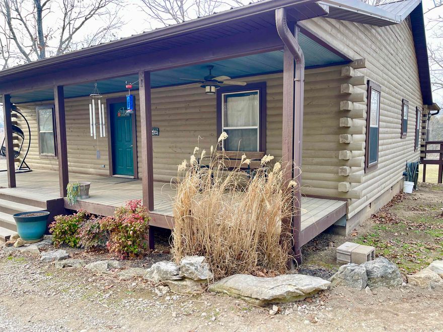 NEW LISTING IN SALEM AR! LOG Home in Fulton County on 5.41 Acres. 3 bed, 1 bath log home offering 1,769 sq ft of rustic Ozarks charm with modern upgrades. Dishwasher and refrigerator(2026) Open floor plan, featuring hardwood floors, vaulted tongue-and-groove wood ceilings, and metal ceilings in the sunroom and bedrooms. REMODELED full bathroom (2026) with a genuine PORCELAIN claw foot tub. Covered front and back PORCHES to enjoy the peacefulness.  A new metal roof (2024), ELECTRIC/SOLAR heat pump, propane fireplace, and SPRAY FOAM insulation under the floor provide year-round comfort and energy efficiency. Home is inside city limits; acreage is outside city limits for added flexibility. CITY WATER and septic system included. Situated on 5.41 acres with a SEASONAL CREEK, this property is ideal for deer hunting and outdoor living. Enjoy a private shooting range, circle driveway, extra landscaping with beautiful huge boulders, dogwood, pecan, weeping willow trees and crepe myrtle, Japanese maple. 4 outbuildings, and a NEWER SHOP (2024) perfect for equipment, storage, or workshop space. A rare Salem AR property combining privacy, convenience, and recreational opportunity.