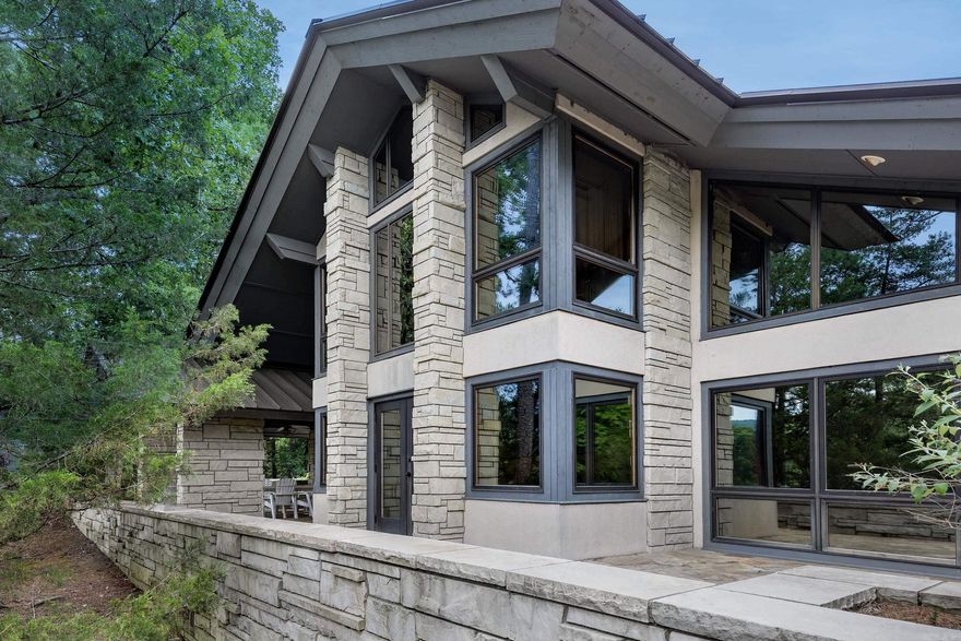 One of Arkansas' most “architecturally intriguing” homes designed by Polk Stanley, Architect Firm & built in 1987 w/ Arkansas Limestone, Flagstone, Marble both inside and outside the home with a nod to the Contemporary Prairie Style developed by Frank Lloyd Wright defined by walls of windows, natural stone, oak trim, custom cabinetry and seamless indoor/outdoor living. There is a “one of a kind” oak entry chandelier, built in marble dining table and more. Home sits on almost 7 acres w/ a private gated entrance & only a 10 minute drive to The Promenade or Wal-Mart. (2) living areas, (3) floor to ceiling stone fireplaces, vaulted ceilings, views of nature from every room, Pella Windows, chef’s kitchen, walk-in pantry, double ovens, large island, & more. Huge bar area w/ ice maker & beverage cooler. Oversized 3 car garage w/ attached shop below, + another detached 30’ x 40’ shop with a half bath. Outside patio area has a beautiful pool w/ a diving board, limestone patio & walk-ways all around the home. Outdoor bathroom & shower & an impressive cantilevered balcony overlooking the Little Maumelle River. Generator. Greenhouse. Smokehouse. Dog Run. New Metal Roof. AGENTS -SEE REMARKS!