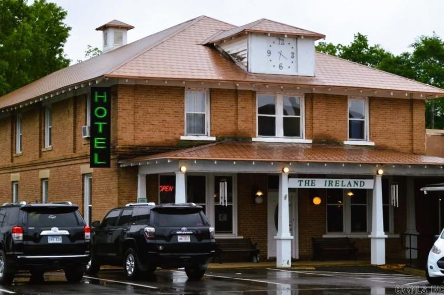 Historical 12-unit Hotel closest to the world-famous Crater of Diamonds where the public can dig for diamonds!! Iconic property that was built in 1889 brick on slab with copper roof and comes fully furnished with custom/locally built cedar furniture! Has a very spacious 3-bedroom, 1 bath with combo kitchen/living managers quarters! Has upstairs and downstairs maid quarters and utility rooms. Also includes a large green space out back that could be made into extra parking etc.  All situated on the downtown Courthouse roundabout that has several antique shops and diners to browse on .34 of an acre.