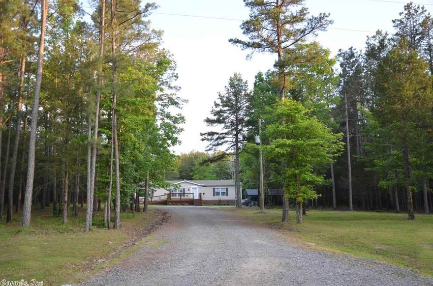 Exceptionally nice 2000sf doublewide on brick foundation, private setting on 3.2 acres & only 3 miles from the marina!  Finished out nicely with sheetrock & crown molding, gorgeous kitchen, large bedrooms, walk-in closets, car carport, tool shed, & very nice decks on front & back of house. Large laundry room, fenced back yard & large wooded area for the kids to explore.  House is well taken care of, very clean & smoke free.  Home is priced to sell!  Move-in ready!