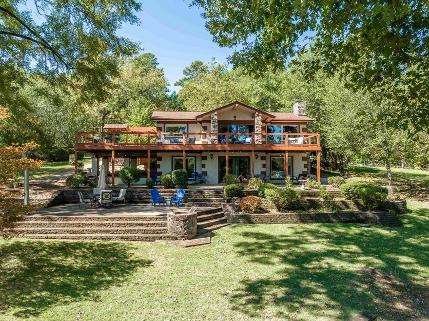 CAUTION: Will fall in love at first showing. Located in a beautiful, quiet neighborhood on Lake Hamilton this home has Two covered boat docks with a boat lift and jet ski lift, two RV parking spots with hook ups, gradual concrete steps into lake, outdoor shower, built-in firepit, private gated entrance, whole house water purifier, NEW roof July 2023, NEW water heater November 2023, NEW HVAC system 2022. Currently used as a short-term rental and vacation home, located just outside of Hot Springs City limits with glowing perfect score ratings.