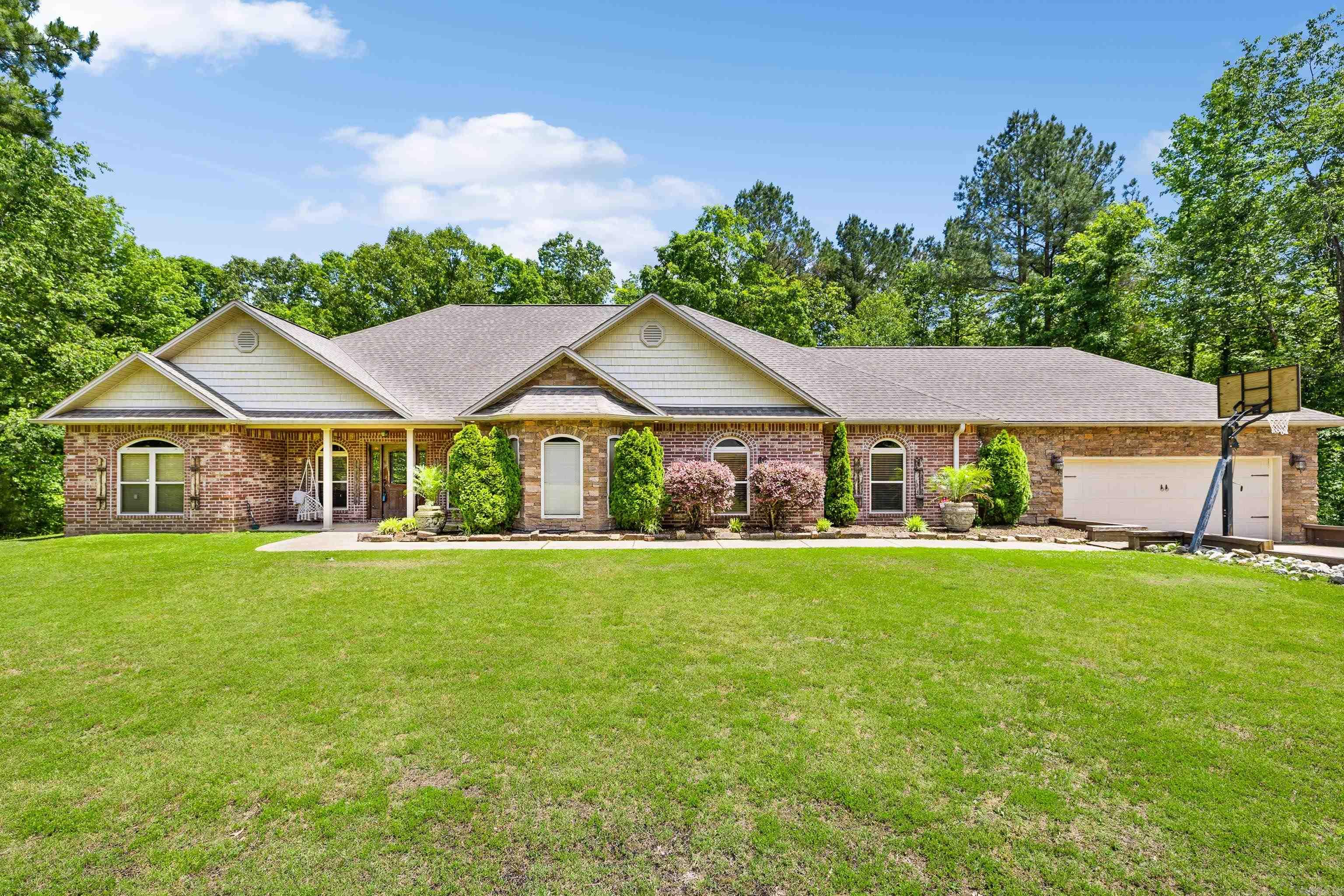 Beautiful Home on 3.44 acre Corner Lot in Sought-After River Ranch! Enjoy the best of country living just minutes from I-30 and downtown Benton in this stunning home located in the desirable River Ranch Phase III subdivision. This spacious residence features 4 large bedrooms, including a luxurious primary suite with oversized closets and a spa-like bathroom. Step into a grand foyer that opens to a generous living area highlighted by a rock-accented fireplace. The kitchen is a chefās dreamāperfect for cooking and entertaining. Two additional flex rooms offer space for a formal dining area, den, or playroom. Additional highlights include a built-in safe room, mudroom, oversized two-car garage, and a screened-in back patio overlooking a large, private backyard with wooded surroundings. This home is filled with features that must be seen in person to be fully appreciated