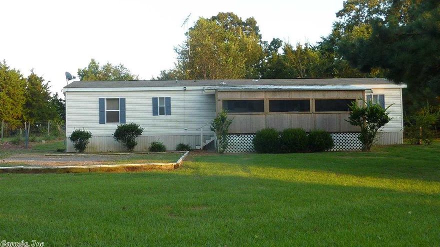 Perfect country living for a commuter traveling East or West. Cozy 2008 Mobile Home on 1.2 acres a short distance from major cities via I-40.  Fully fenced and cross-fenced and enough room for a large animal or two.  Extra storage sheds and convenient small animal door, porch and dog run. Deep shaded lot with fire pit and mature grape vines (grapes ready soon!). Enough level space for a large garden too. Refrigerator, washer & dryer and Stainless stove stay! Mineral rights convey. (See agent remarks.)