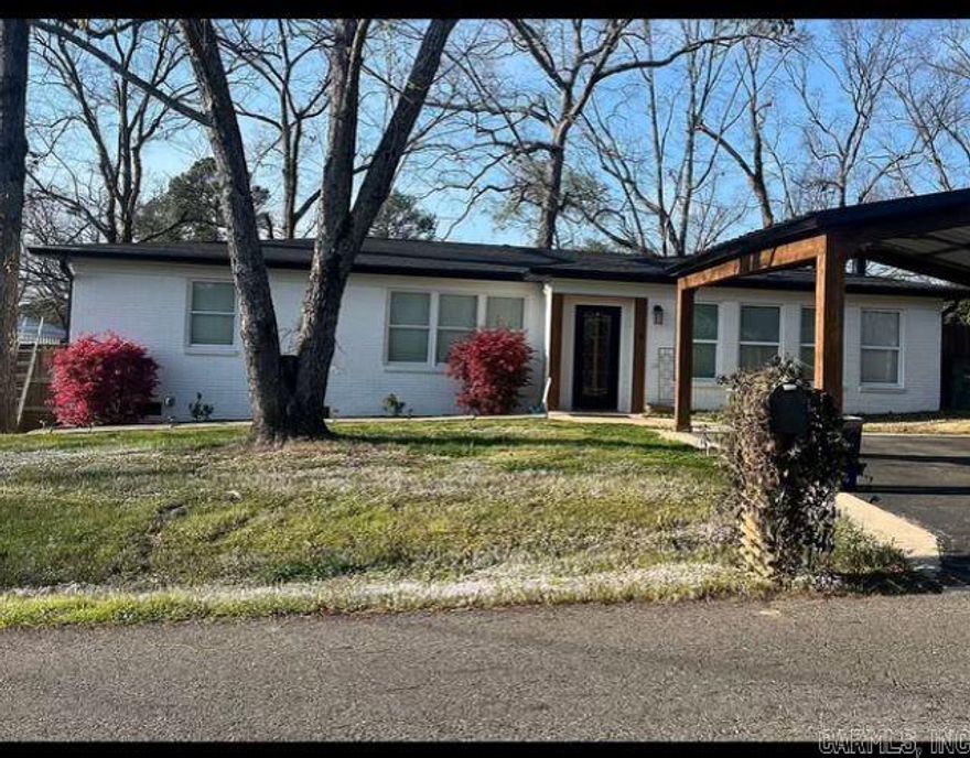 Remodeled 3 bedroom 2 bath home with lake view on a large fully fenced lot/  Garage workshop, new roof, open floor plan.