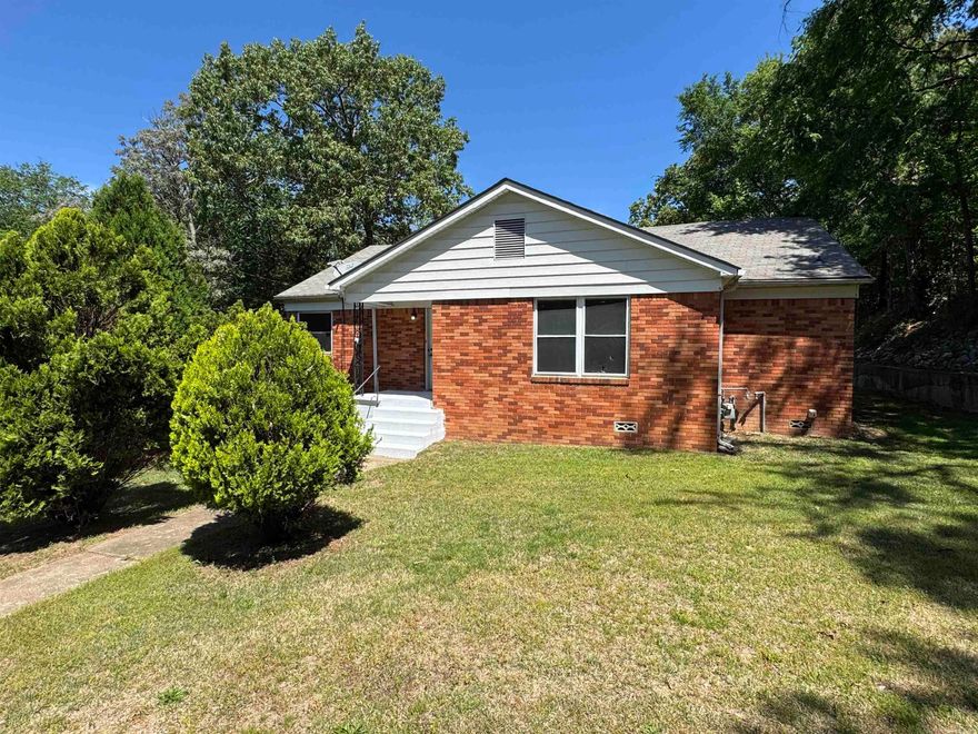 1308 West St. Louis Street in Hot Springs, Arkansas, presents a unique investment opportunity with two separate residences on a single 0.36-acre lot.  Both houses have hardwood floors, The front house is a 1,679 sq ft brick home featuring 3 bedrooms, 2 bathrooms, central heating and air conditioning, and an attached garage. The rear house is a 2-bedroom, 1-bathroom unit with separate utilities, ideal for rental income or use as a guest house. The property is fully fenced and has been maintained in excellent condition. Located within the Hot Springs School District, it is conveniently close to shopping centers, parks, and hospitals.   Square footage of houses are combined  Little house is 766 Sq Ft Big house is 1732