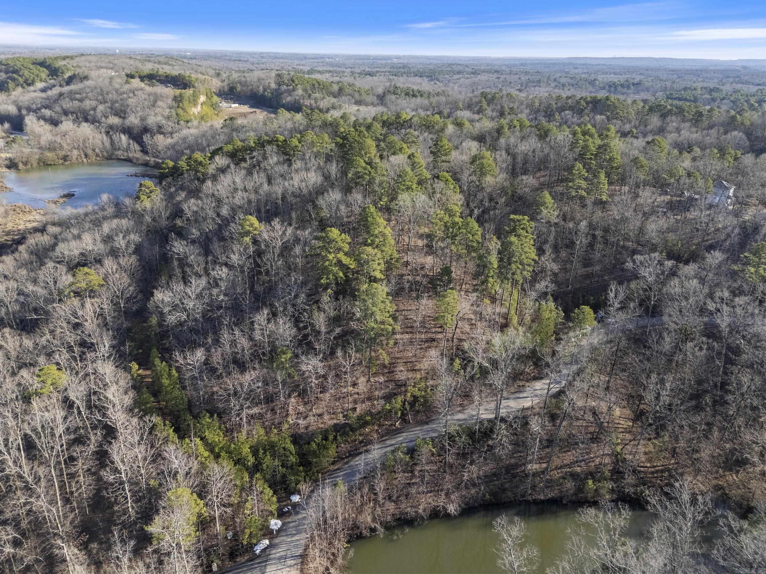 Come see the views from beautiful gated Estates at McHenry! This large, wooded 6.42 acre lot is the perfect place to build your dream home. Lot comes ready to go with city water, underground utilities, high speed internet, paved roads and septic approved. Bill of assurance restriction is 2500 sq ft minimum for homes. Enjoy the feel of privacy in a gated community all while being close to shopping, entertainment, restaurants and medical facilities.