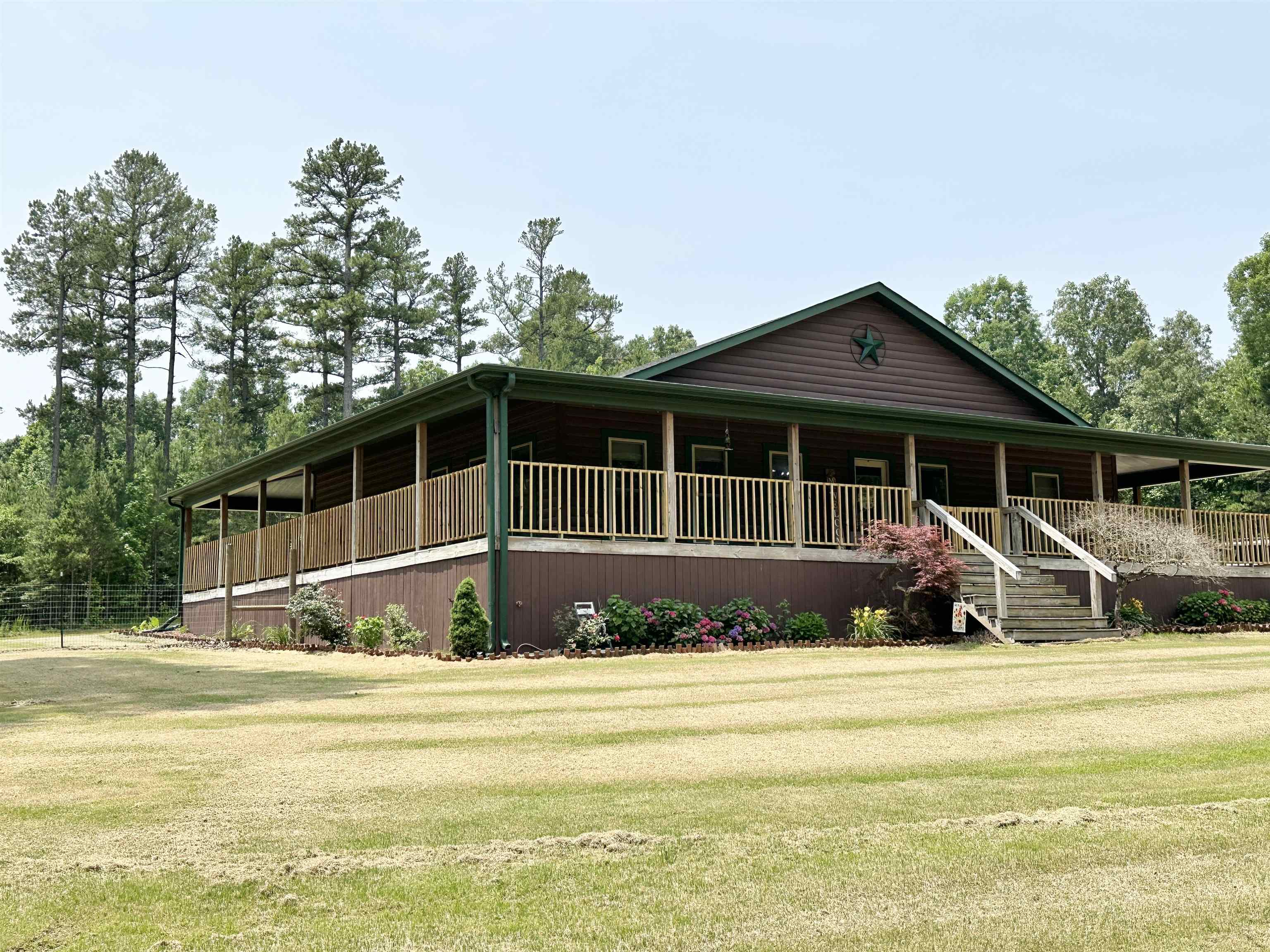 Charming Log Home with Wrap-Around Porch and Modern Updates This beautifully maintained 3-bedroom, 2.5-bath log home offers rustic charm with modern conveniences. Featuring two spacious master bedrooms, this home is ideal for multigenerational living or added privacy for guests. The layout is handicap accessible, ensuring comfort and functionality for all. Enjoy the outdoors year-round on the expansive wrap-around porch, perfect for relaxing or entertaining. Inside, you'll find new flooring, fresh paint, and new appliances, including a modern sink upgrade. The roof is only 3-4 years old, offering peace of mind for years to come. One of the standout features is the huge workspace room off the garage ideal for a home business, creative studio, or hobby space. The property is fully fenced, perfect for pets or added security.