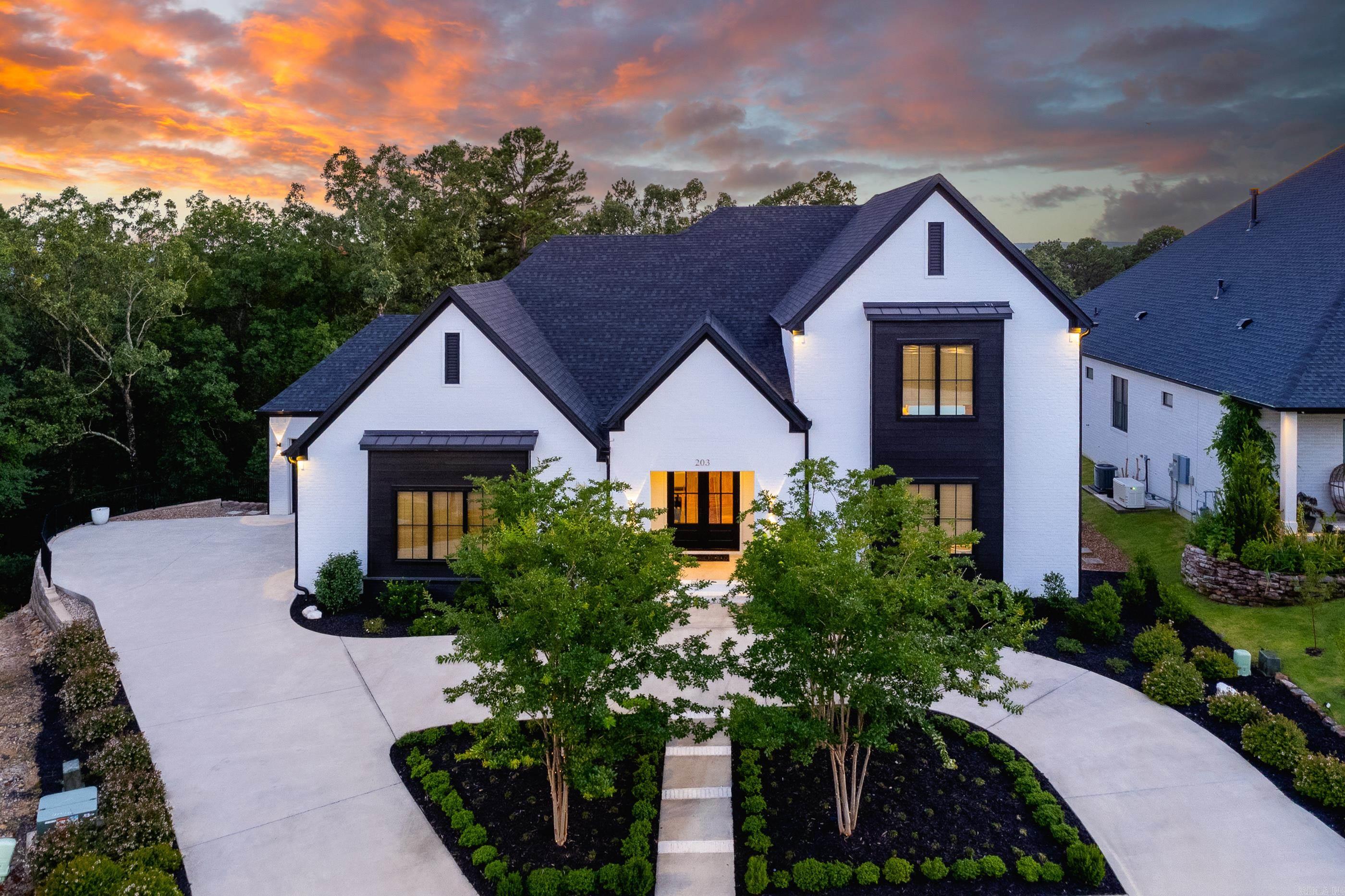 Custom designed home on cul-de-sac w/16'x26.5' covered porch w/ FP offering total privacy looking onto wooded greenspace. Entry foyer welcomes you into the open concept living area w/ 13' ceilings, WBFP & built-ins. Wall of glass offers view beyond the porch to the wooded privacy. Living area flows into entertaining-size dining area and into a chef's kitchen. Top-of-the-line appliances include 2 Fisher-Paykel 2-drawer dishwashers, KitchenAid 36" 6 burner gas cooktop, Sharp microwave drawer oven, Electrolux side by side refrigerator/freezer, KitchenAid icemaker & KitchenAid double wall ovens. Honed granite countertops & marble waterfall center island for casual dining. Butler's pantry offers tremendous extra storage. Primary BR w/elegant bath & 2 walk-in closets, 2nd BR & 3rd BR on main level share a Jack&Jill bath. Library/office w/ built-in desk & shelves, powder room for guests & utility room with sink & storage. Pair of floor-to-ceiling Armoire storage units in mudroom. Upstairs bonus room w/wet bar & beverage refrigerator. Music/Media room finished w/carpeted walls & floor+insulated on all 6 surfaces w/acoustic blocking. 4th BR w/ built-in shelves & cabinets &3rd full bath.