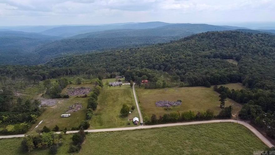 A little piece of paradise with 921 feet of Ozark National Forest frontage!  23 acres of prime land located just off scenic Hwy 21 about 10 minutes from Clarksville, minutes from Lake Ludwig, including the new Mt. Bike Trails, Glory Hole Falls, $ a short drive to Big Piney Creek, & The Mulberry River.  The majority of the property is level pasture at the front and declines in the back opening up to spectacular views to the NW overlooking the Ozarks.  Rural water, Eclectic, & high speed fiber on property.  2 entries off CR 4501.  Will consider subdividing.  Minor deed restrictions to protect the property values.  Recent survey, abundant wildlife, partially fenced, & includes a metal barn.  Abundant opportunity for recreation, a cabin, or forever home!!!