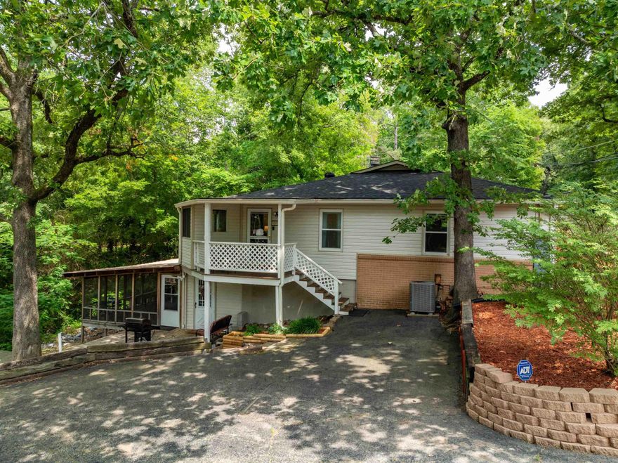 Enjoy beautiful sunrises and sunsets from your own spacious home situated on 4 lots with approximately 50' of lakefront on Lake Hamilton. With 2 bedrooms, 2 baths, and over 2,000 square feet, this cottage-style home offers a large 20'x16' screened in deck overlooking the gazebo, hot tub, and Lake Hamilton. Upstairs is the living room with fireplace, large sitting area overlooking the lake, bedroom with ensuite bathroom, office space, second full bath, oversized bedroom with spacious closet and attached storage room. Enjoy the lakeside view from the dining area downstairs along with a second living area, the kitchen, and laundry room.  HOA includes access to 2 neighborhood parks with boat ramps.  The roof of this home is approximately 5 years old. The Lenox Heat and Air units are approximately 9 years old and serviced twice annually. The plumbing has been updated and extra insulation has been added in the attic. The large tankless hot water heater is 3 years old. This entire home is electric.  This turnkey property is situated outside of the city limits and is currently being used as a vacation rental.  AGENTS SEE REMARKS.