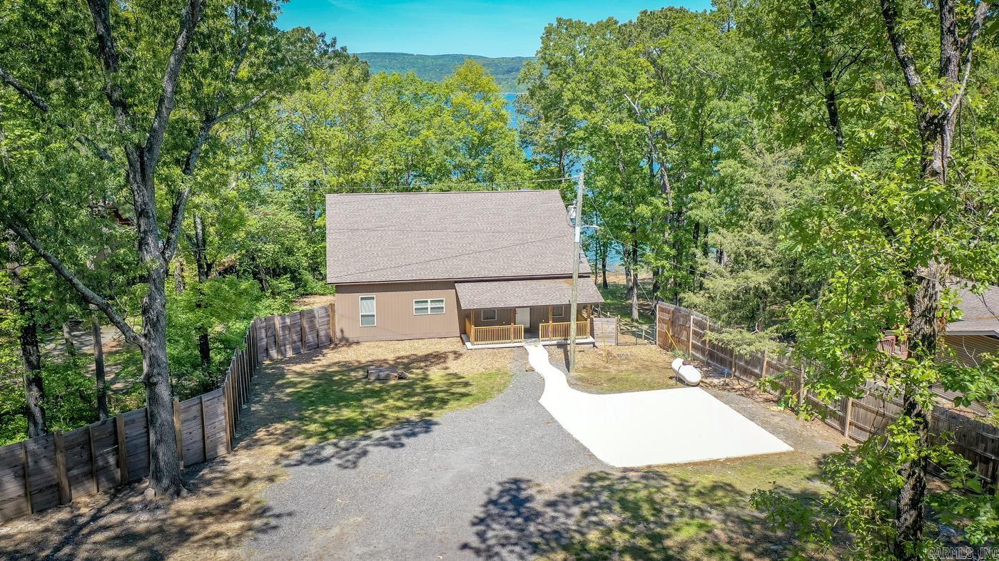 Great Lake Access with low white line, gentle slope to the water & Lake view from your covered back deck. Shoreline is located right at the mouth of "The Narrows" across from "Poker Island". Master Suite Downstairs with Large tiled walk in shower plus a walk in closet with built in drawers. Open Kitchen and living space for entertaining, gas fireplace, fenced in area for your pets, tongue & grooved wood ceiling on back porch. Upstairs offers a 2nd living room area that would make a great space for a game room with walkout door to another covered deck, 3 guest bedrooms with full bath & wet bar upstairs as well. LVP flooring throughout the home with exception of the 3 carpeted bedrooms upstairs . Excellent Floor plan!!!