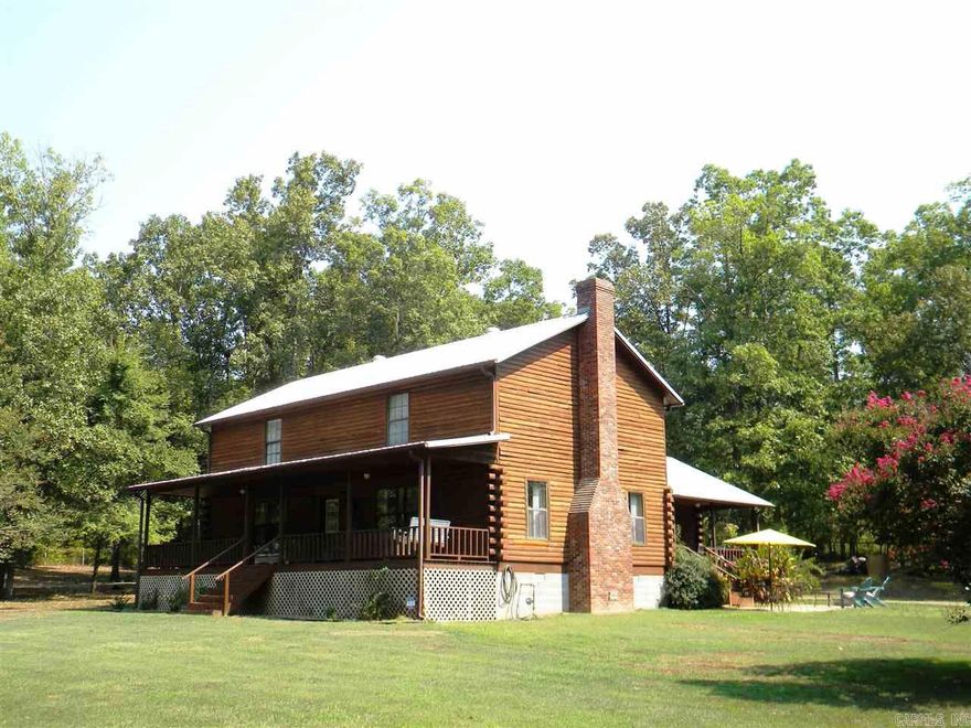 Rustic Log Cabin on Gorgeous 3.39 acres with a pond, 30x30 Garage/shop w/ attached 2 car carport.  Main level exterior is log, top story is Redwood siding. New wood laminate and new tile flooring and paint. Huge greatroom with tall vaulted ceiling, rustic walls. Lrg kitchen/dining area Stainless appliances  French doors lead out to the covered side porch. Country Front Porch looks out over the Pond! 2 BR down with Jack & Jill bath. 1/2 guest bath down. Massive MasterBedroom Up w/ private bath. See remarks!