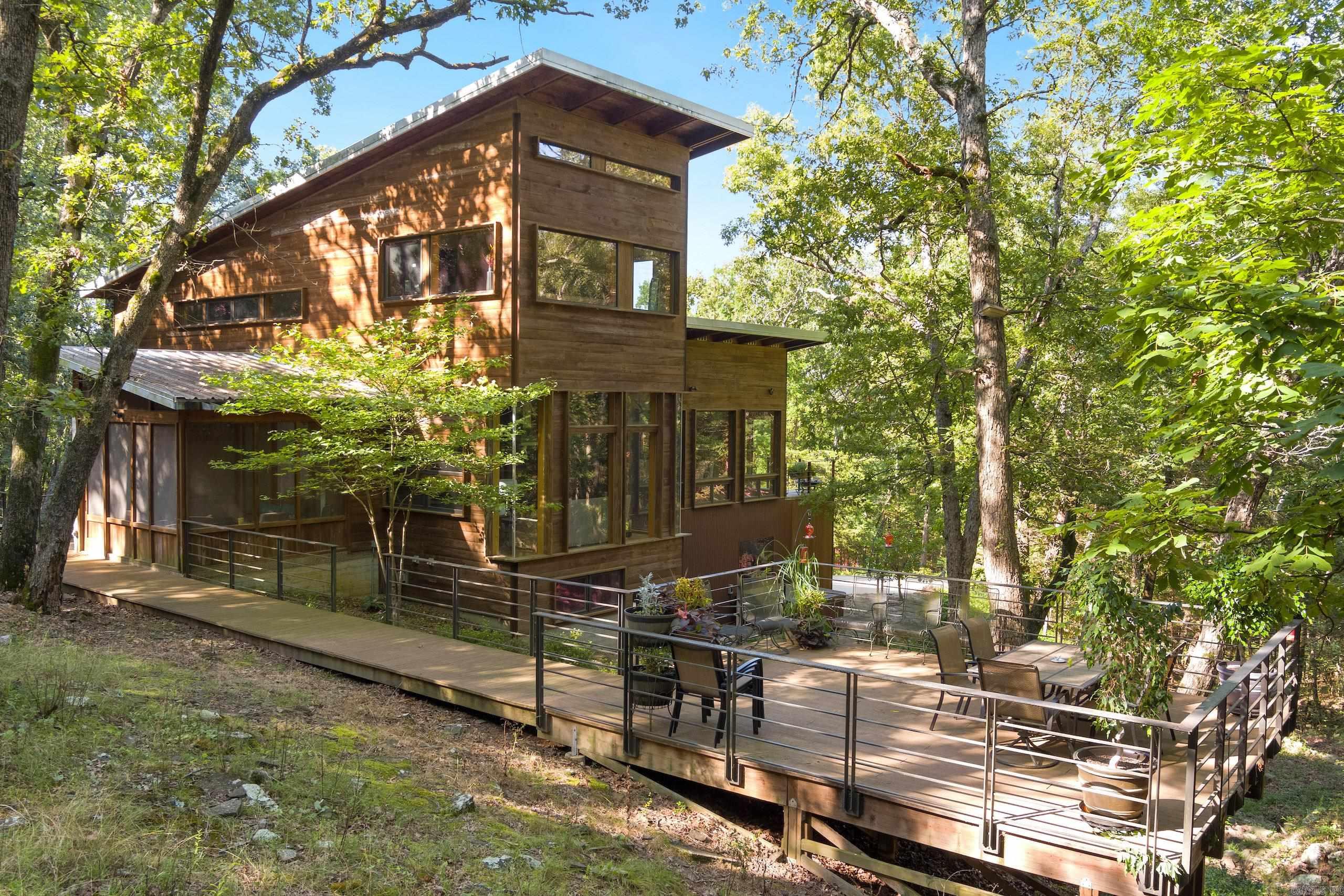 Welcome to one of the most one-of-a-kind properties in the Ozarks. If I were to say this place, had it all, I think it would be an understatement, but truly, this property has something for everyone. Being just minutes from Elkins and just a short drive to Fayetteville, but with all the seclusion and privacy of any place in the Ozarks. This luxury rural oasis custom home is a rustic contemporary architectural masterpiece that will not disappoint. With three levels that offer 4 bedrooms and 3.5 baths.
