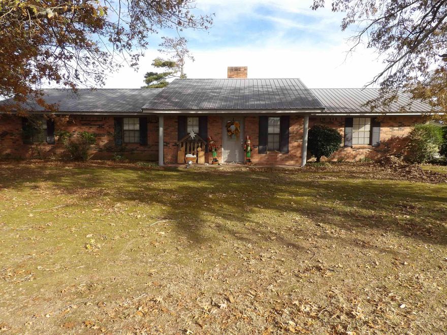 This three-bedroom, two-full-bath home features a two-car garage and a large workshop out back with plenty of storage. It sits on a spacious double, shady lot in a nice, quiet country community just south of Dumas, Arkansas.