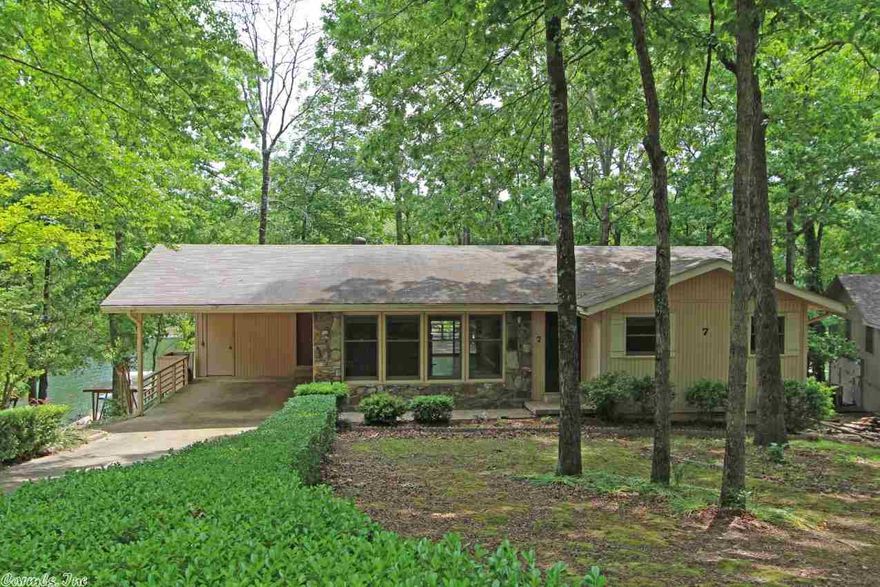 PUT THIS HOME ON YOUR "SHOW NOW" LIST. RELAX AND ENJOY THE BEAUTIIFUL LAKE FRONT AND VIEW. Open floor plan. Huge deck. Updated and refurbished 2014:New Granite, Stainless Steel Appliances including Sink, Dishwasher, Electric Range and Microwave. Laminate Flooring, Tile and more!. Covered boat dock 2007. Roof 2007, Heat Pump 2004.  Easy access to lake. LOWER LEVEL HEATED AND COOLED  MULTI-PURPOSE ROOM WTH HALF BATH.  Work shop.   Great for permanent residence or vacation home. Show Room Ready!