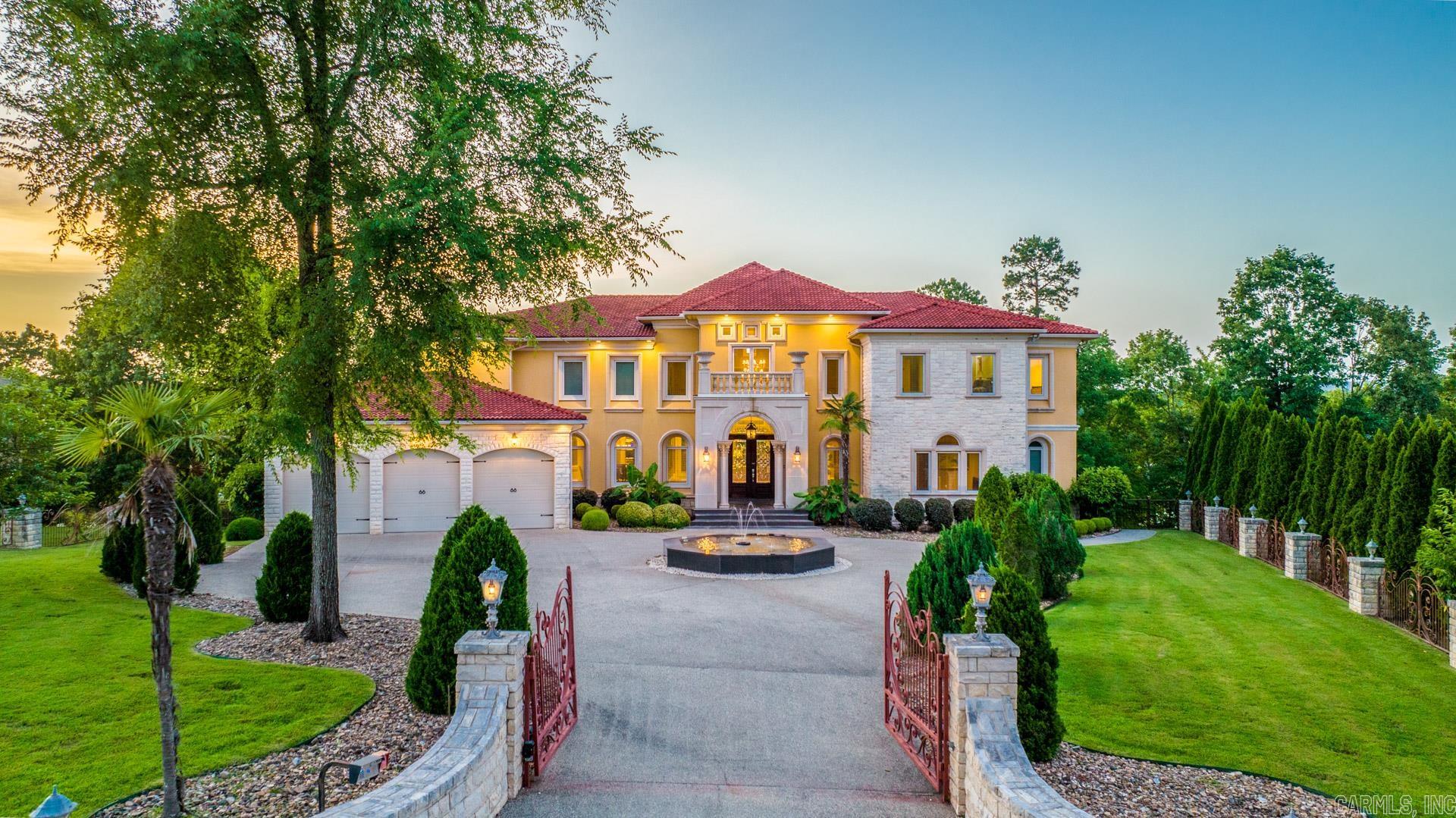 Past ornate gates and a grand granite fountain, 170 Cougar Terrace of Hot Springs is a breathtaking vision on the main channel of Lake Hamilton. This custom Spanish/Mediterranean home makes the absolute best of stunning panoramic views from multiple levels and offers a front-row seat to unbeatable waterfront luxury. Lake Hamilton becomes an extension of your backyard with a two-stall boat dock at the ready for endless days of fishing, swimming, and sightseeing. Soaring ceilings and exquisite amenities await indoors, like the inviting sauna and cozy wine cellar. Outdoors, alfresco entertainment reaches new heights with lake-facing terraces, balconies, and a stunning pool with a premier waterfront view. Stargaze from the vast poolside terrace before retiring to the primary suite, where a walk-in wall of showers and column-flanked soaker tub will suit any tastes for some well-deserved R&R. This home is being sold furnished and "As Is".