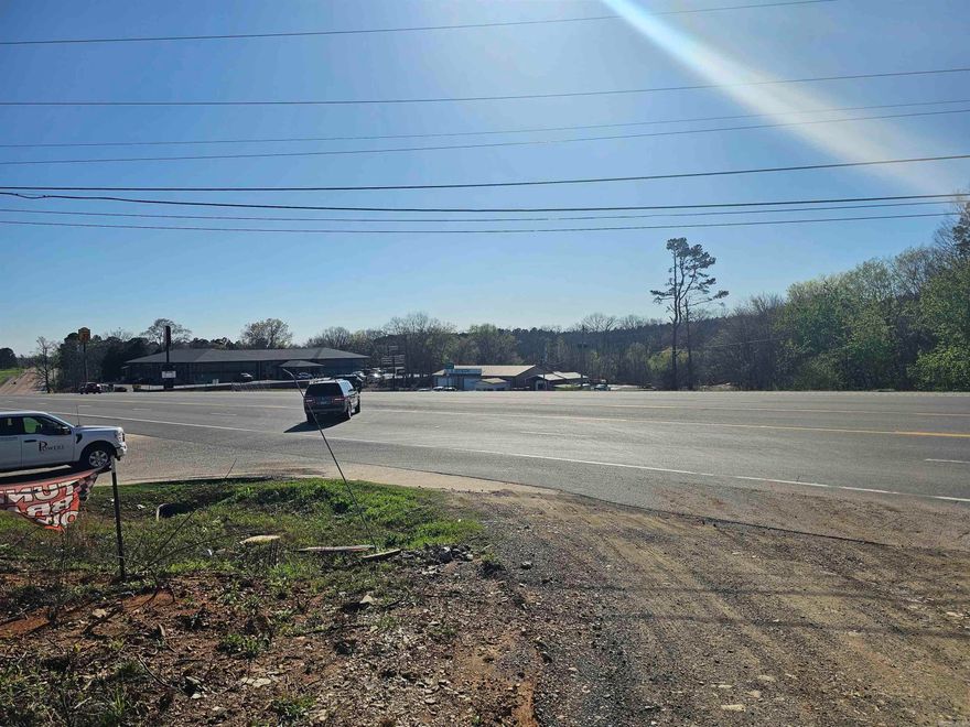 Looking for a great location for your business? THIS ONE HAS GOOD ROAD FRONTAGE. THIS HAS BEEN A TIRE SHOP FOR A COUPLE OF YEARS. THE BUILDING WAS DAMAGED BY THE WINTER STORM THIS YEAR, AND THE SHOP BAYS COLLAPSED. THE OFFICE PART OF THE BUILDING AND THE UNFINISHED APARTMENT ON THE UPSTAIRS WAS MOSTLY UNDAMAGED. THE CONCRETE PAD OF THE SHOP IS IN GOOD SHAPE AND WAS POURED 12 INCHES IN ABOUT HALF TO BE ABLE TO SUPPORT HEAVY TRUCKS AND LIFTS. THE APARTMENT WILL BE FINISHED OUT, AND THEY WILL REBUILD ONE BAY OF THE SHOP AT THE CURRENT PRICE. IF YOU NEED  TO BUILD A BIGGER SHOP, LET US KNOW, AND WE CAN NEGOTIATE WHAT YOU NEED AND THE PRICE TO BUILD IT. THERE IS OVER 13.5 acres here, so the potential is unlimited on what you can do. There are 2 SEPARATE ELECTRICAL BOXES FOR YOUR SHOP AND OFFICE NEEDS. THE OLD TIRES AND DEBRIS WILL BE REMOVED BEFORE CLOSING. CALL TODAY TO SCHEDULE YOUR WALKTHROUGH