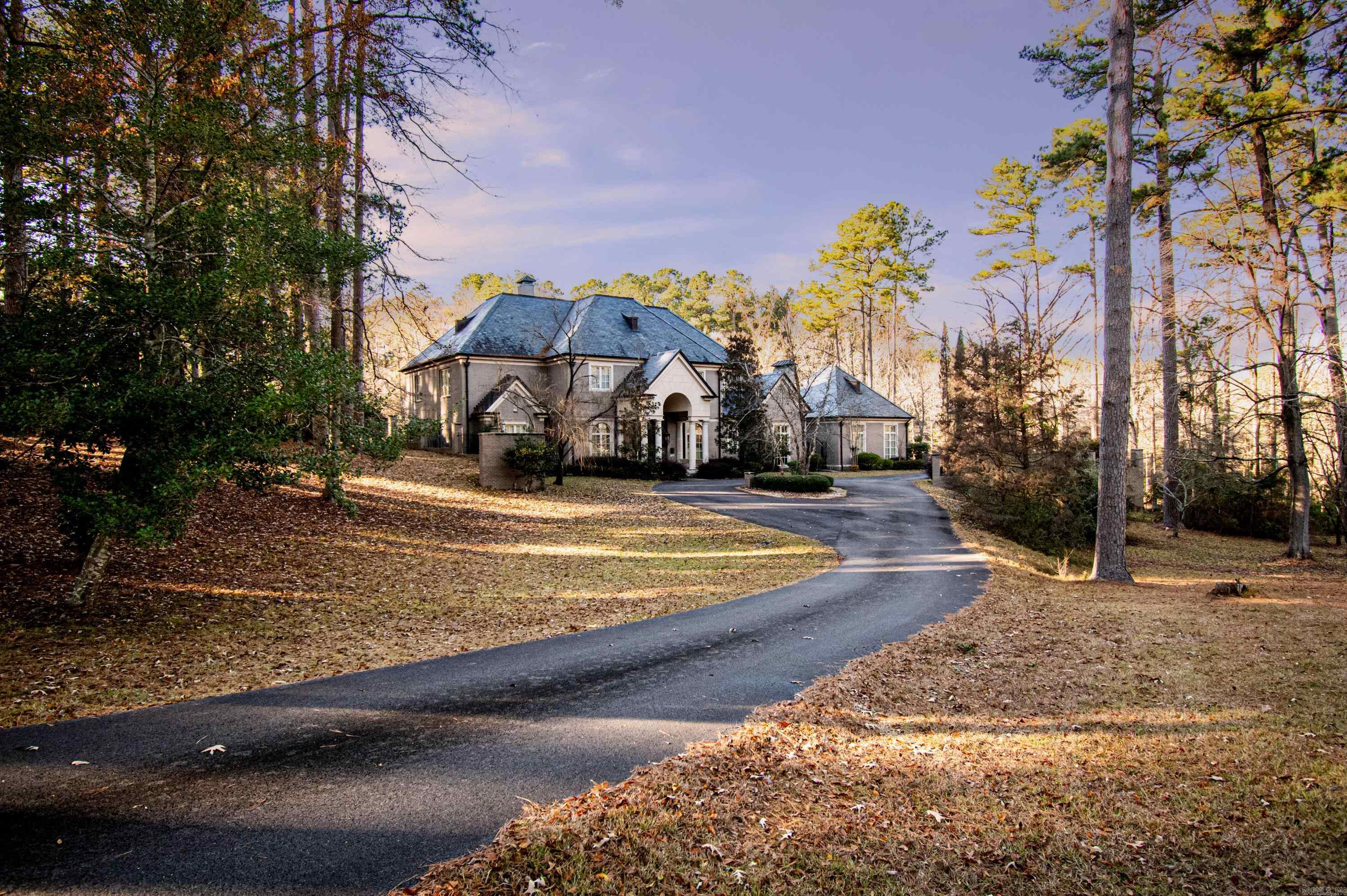 Step into your private mansion with this 4-bedroom, 3-bath, 2-half-bath showstopper spanning over 7,400 square feet of elegance. Nestled on nearly 1 acre, this property is surrounded by stunning iron and brick fencing and welcomes you with a grand circle drive. Enter into a breathtaking foyer with a dramatic catwalk and staircase that opens into a grand living room featuring floor-to-ceiling windows. Throughout the home, custom arches and intricate molding add timeless charm. The chef’s kitchen is perfect for culinary creations, complete with a butler’s pantry for extra storage and prep space. Cozy living and dining areas close to the kitchen provide the perfect setting for quiet evenings when you’re not hosting. Privacy is paramount in this home, with spacious bathrooms and walk-in closets. You'll love the beautiful wooden office. A gorgeous balcony spanning two stories, ideal for entertaining even the largest gatherings. Considering outdoor upgrades? The outdoor storage room is primed to become a pool house if you decide to add a pool. And don’t worry about the stairs—this home comes equipped with an elevator.