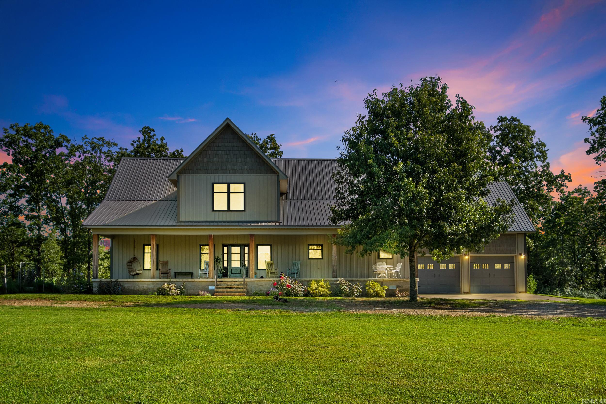 Welcome to your own private retreat! This custom-built, stunning 3BR, 3.5BA home sits on 18 peaceful acres and offers 3,704 sq ft of thoughtfully designed space. Features include an office with built-ins, two spacious living areas, abundant storage, a large laundry/mudroom, and an oversized garage with a safe room. The main-level primary suite includes access to a private covered deck and a spa-style bathroom with a freestanding tub, tiled walk-in shower, custom cabinetry, and a large built-in closet. Upstairs are two oversized bedrooms, each with a full bath and multiple closets—plus a central second living area and a laundry chute. The open-concept kitchen/living area features vaulted ceilings, natural light, and beautiful views. Exterior highlights include a 54x60 shop (30x40 enclosed, with lean-to storage and two overhead doors), a circle driveway, large covered porches, and a 4-acre stocked pond with a dock. A rare find offering space, comfort, and privacy! *Ask to see video tour and floor plans. Proof of funds or pre-approval are required before showings.
