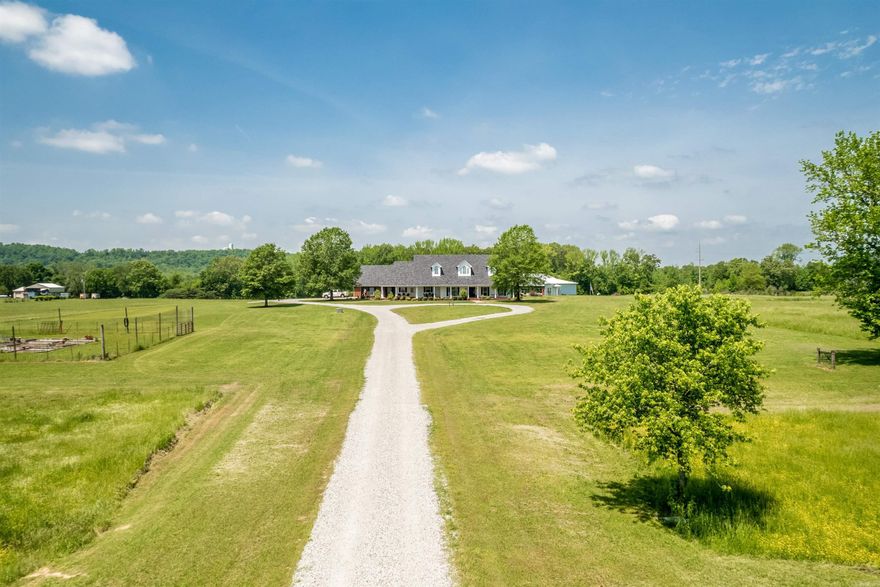 Within Greenbrier, AR city limits and minutes from shopping and top rated Greenbrier schools, a rare opportunity to own 20 private acres, a luxurious estate with pool and shop all in a great location awaits your visit. This estate delivers a peaceful country setting without sacrificing accessibility. This custom home features a home office, formal dining room, two spacious living areas, and a gourmet kitchen with an island and separate scullery prep kitchen designed for effortless entertaining. A flex room above the garage provides a 4th bedroom or bonus space. Rich hardwood floors, custom built-ins, and extensive trim work highlight the quality craftsmanship. The split floor plan offers a private primary suite with a custom closet, direct laundry access, and secure saferoom. Expansive covered porches overlook beautiful acreage. The backyard retreat includes a resort-style pool and a fully equipped shop with bath, kitchenette, and fireplace—ideal for guests, hobbies, or year-round entertaining. Fresh paint and thoughtful updates make this move-in-ready luxury acreage property in Faulkner County truly one of a kind. Just imagine—don’t miss it