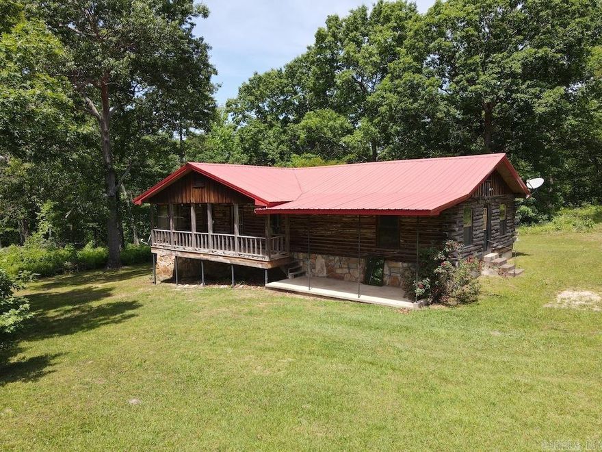 Tucked into the rolling hills of Izard County, Arkansas, this unique 30-acre homestead features a handcrafted log home built from timber harvested directly from the property. Offering approximately 1,800 square feet, the home is full of character with walnut cabinets and Paulownia wood walls and trim milled on-site. Inside, you’ll find an open-concept kitchen, dining, and living area, two main-level bedrooms, a full bathroom, a cozy library nook, and a large screened and covered deck perfect for enjoying peaceful Ozark evenings. The basement includes an additional bedroom, full bathroom, extra storage, and a tornado shelter/root cellar. An outdoor wood boiler helps keep the home warm through the winter. The land is loaded with mature hardwoods, rock outcroppings, and excellent deer and turkey hunting habitat. A ridge-top field offers food plot potential, while year-round Macedonia Creek winds through the property for over 1,000 feet. Located just minutes from Melbourne and near the White River, this property offers privacy, recreation, and true Arkansas charm.