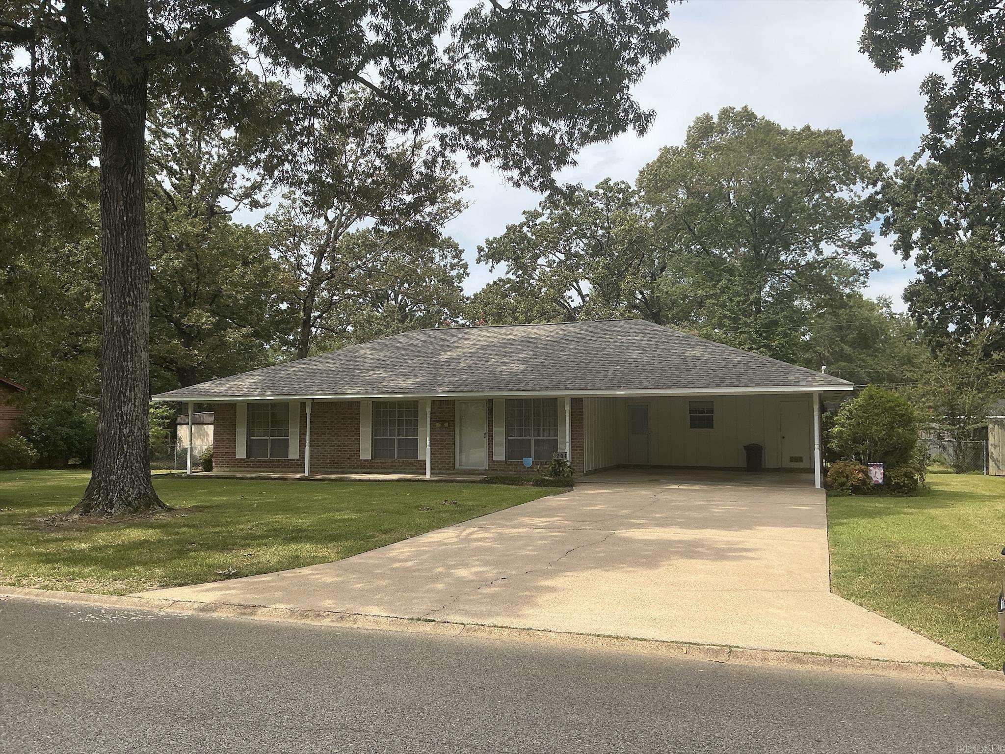 This beautiful move-in-ready home features sitting on a large lot has a wonderful floor plan with a large formal living room, formal dining room with built-ins, large den (640 sq ft) with fireplace and built-ins, backdoor leading to the covered patio and large backyard, kitchen with double ovens, dishwasher, refrigerator, and small breakfast area with double doors leading to the formal dining room, laundry room with storage over w/d, tile floors in kitchen and laundry room, luxury vinyl is in the den, formal dining room and hall, three bedrooms with carpet, large closets, two full baths, hall bath with shower over bathtub, and the master bath also with shower over bathtub. Home also features beautiful curb appeal, a double carport with concrete driveway, outside storage building, privacy fence in the backyard and cyclone fence in front, covered patio and side porch also. The central unit is gas heat, 2005, hot water heater gas and a new Architectural roof, August 2025. Property is located within walking distance to Anderson School and park with the exercise equipment. This home is one you must see to know all the amenities.