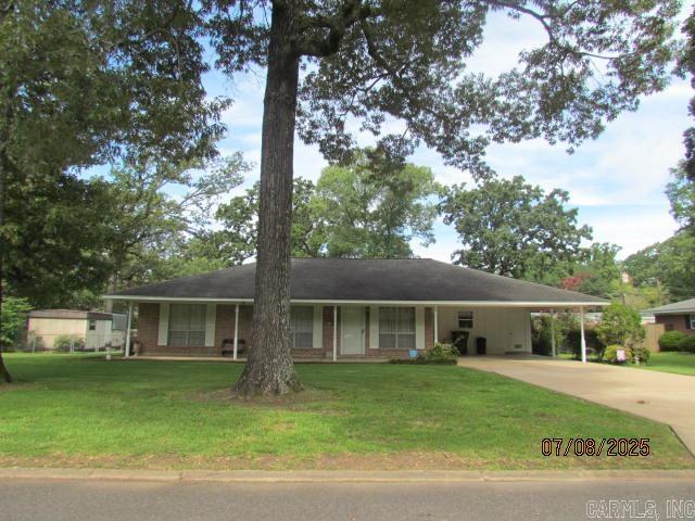 More pictures after estate sale. This beautiful home features a wonderful floor plan with a large formal living room, formal dining room with built-ins, large den (640 sq ft) with fireplace and built-ins, backdoor leading to the covered patio and large backyard, kitchen with double ovens, dishwasher, refrigerator, and small breakfast area with double doors leading to the formal dining room, laundry room with storage over w/d, tile floors in kitchen and laundry room, luxury vinyl is in the den, formal dining room and hall, three bedrooms with carpet, large closets, two full baths, hall bath with shower over bathtub, and the master bath also with shower over bathtub. Home also features beautiful curb appeal, a double carport with concrete driveway, outside storage building, privacy fence in the backyard and cyclone fence in front, covered patio and side porch also. The central unit is gas heat, 2005, hot water heater gas and a new roof will be put on house as soon as possible depending on contractor's schedule. It is located within walking distance to Anderson School and park with the exercise equipment.