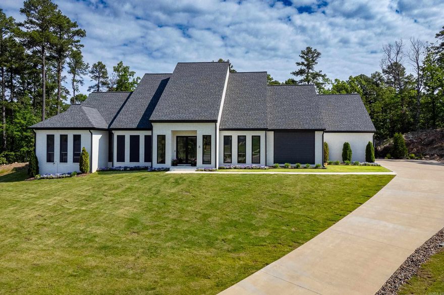 Welcome to the modern luxury of 6 Falstone. Completed in 2022, a wealth of desirable features and custom finishes. 12-foot ceilings on the main floor create a sense of spaciousness throughout. Practical additions like a mudroom and a sizable pantry, with room for an additional refrigerator. The kitchen is a culinary masterpiece, featuring high-end stainless appliances, including a wine refrigerator, ice maker, and Miele coffee maker, catering to the needs of even the most discerning chef. The master suite serves as a sanctuary, offering an office or exercise room, zero-threshold showers, and a generous closet  with laundry. Additional guest bedroom downstairs. Home features a tankless hot water system. 1000 square foot three-car oversized garage, equipped with hot and cold water hookups. Upstairs, a bonus area with a second laundry area. Two additional bedrooms complete the upper level, providing comfortable accommodation for family members or guests. Outside, the flat backyard offers complete privacy. The covered back porch, complemented by a half bath and new heaters, extend the entertaining space year-round. * Lot next door can be purchased with home. See Agent remarks.