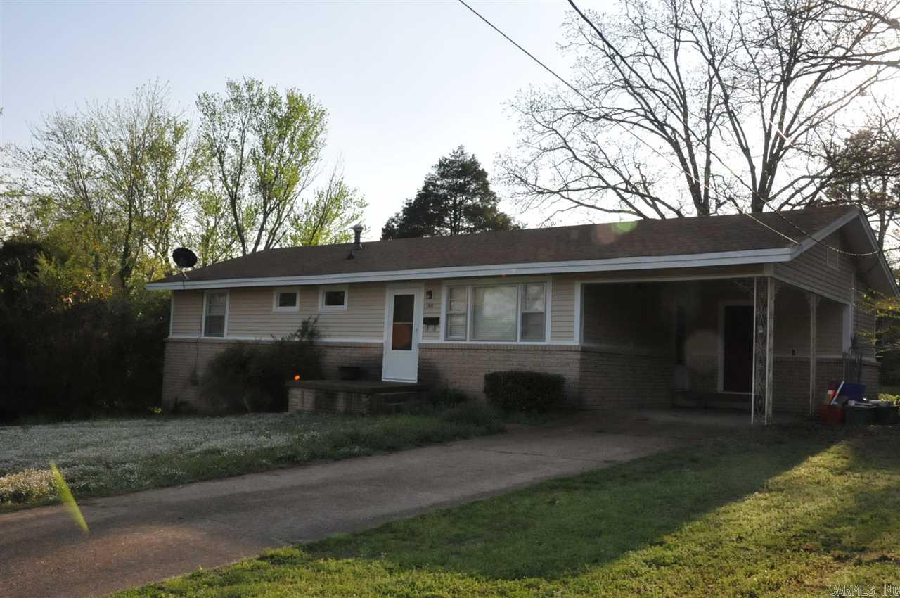 This little retro house is a cutie pie! Conveniently located in the middle of town, walking distance to Harding University. Hardwood Floors in Living Room and hallway are in GREAT SHAPE, and there's solid wood tongue and groove paneling in kitchen. Even the brick is a cool 50's pattern! LARGE back yard with trees is fully fenced.