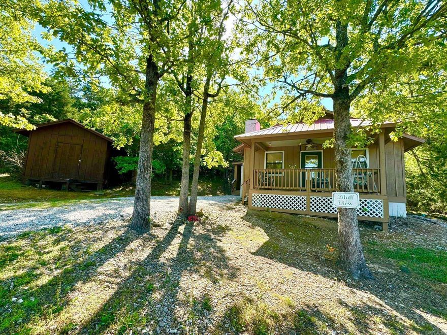 A Charming 2 bedroom, 1 bath cabin overlooking the Ozark Mountains and the White River. This cozy cabin offers breathtaking views of the surrounding landscape where lush greenery meets towering peaks. The exterior has a rustic wooden design with a welcoming covered front porch that offers the perfect spot to sit and enjoy the scenery and nature. Inside, the cabin is completely furnished including a washer and dryer featuring a comfortable living space and a fully equipped kitchen and the bathroom includes a tub/shower combo with the washer/dryer in the same room. Outside, the property boasts 2.5 acres of land with trees and other vegetation adding to the privacy and tranquility. It's ideal for those seeking a quiet getaway from the hustle and bustle of everyday life.