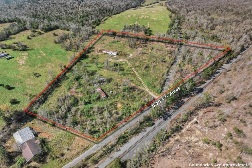 This is 9.79 acres more or less with two city water meters and one septic system. There is currently two mobile homes on the property and both need TLC. The property has paved County Road access and is not far from US HWY 71/59. The property is less than a mile from Tyson and main HWY.