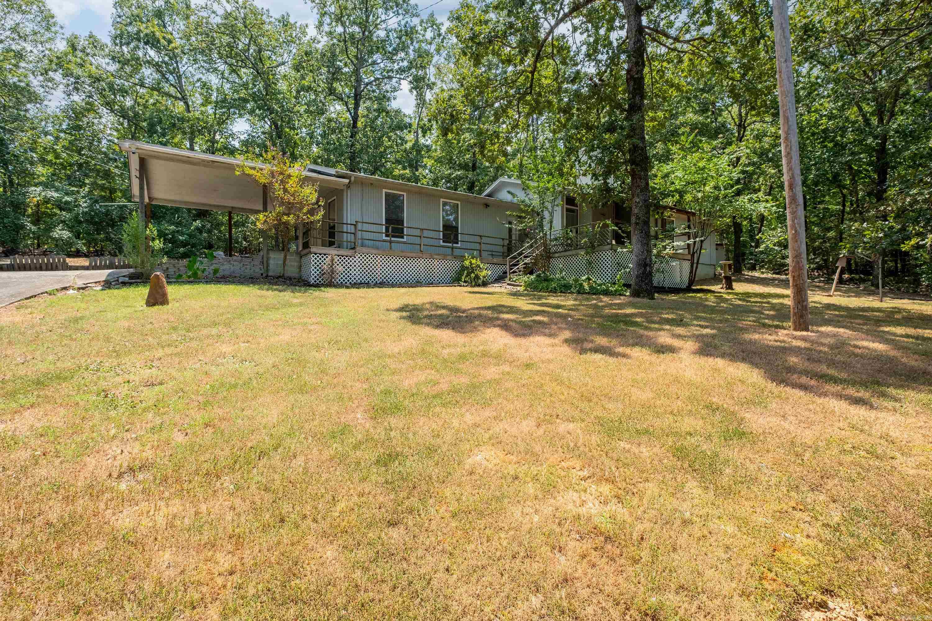 A place to breathe, relax, and call home. Set on 2.67 acres, this property offers two living areas, a covered deck, two storage buildings, and a fenced yard. Updates include roof, new HVAC, and stone retaining wall in backyard āmove in with peace of mind. Fridge, washer and dryer convey. Enjoy partial covered parking and a location that feels worlds away yet close to town. Under probate; offers require judge approval. Should not be a lengthy process. Home to be sold as is. Combo box on gate, please lock back, see remarks for code. Supra for entry on carport door.