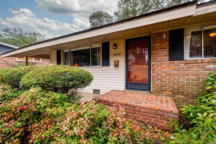 Charming mid-century home offering 3 beds, 2 baths and 1527 sq ft of thoughtfully updated living space!  Original hardwoods floors add timeless character throughout.  Both bathrooms were fully remodeled in 2022 with stone countertops, modern fixtures, updated electrical, a walk-in shower, and an extra-deep soaking tub in hall bath.  The spacious, well appointed kitchen features soft-close cabinetry, designated dining area, ample pantry storage, and adjoined to the year-round outdoor living on the screened-in porch, perfect for relaxing or entertaining.  The generous sized backyard include raised garden beds with drip irrigation ideal for garden enthusiasts.  Additional highlights include fresh interior paint, durable low-maintenance metal roof, and a welcoming brick wall entrance.  This amazing property blends classic charm with modern updates - move-in-ready and full of character!!